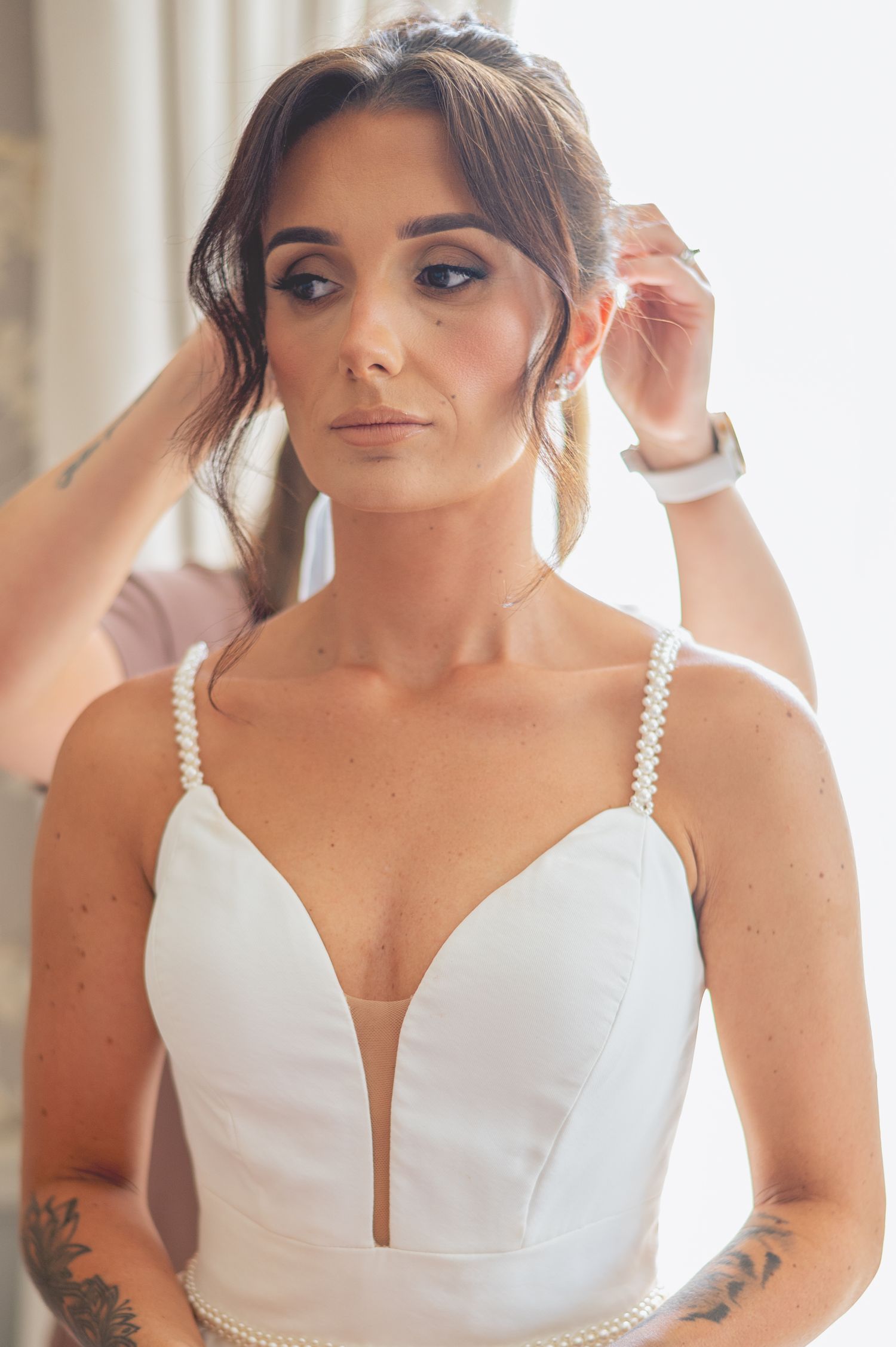 Close-up bridal preparation shots showing wedding dress details.