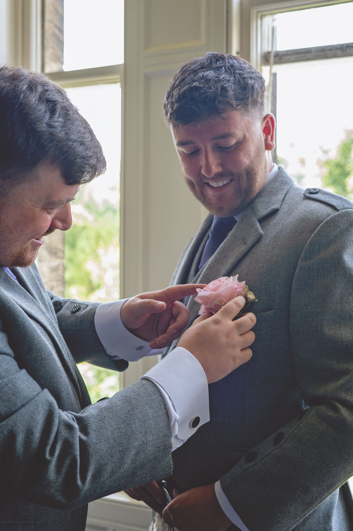 Candid moments of wedding preparations with suits and formal attire.