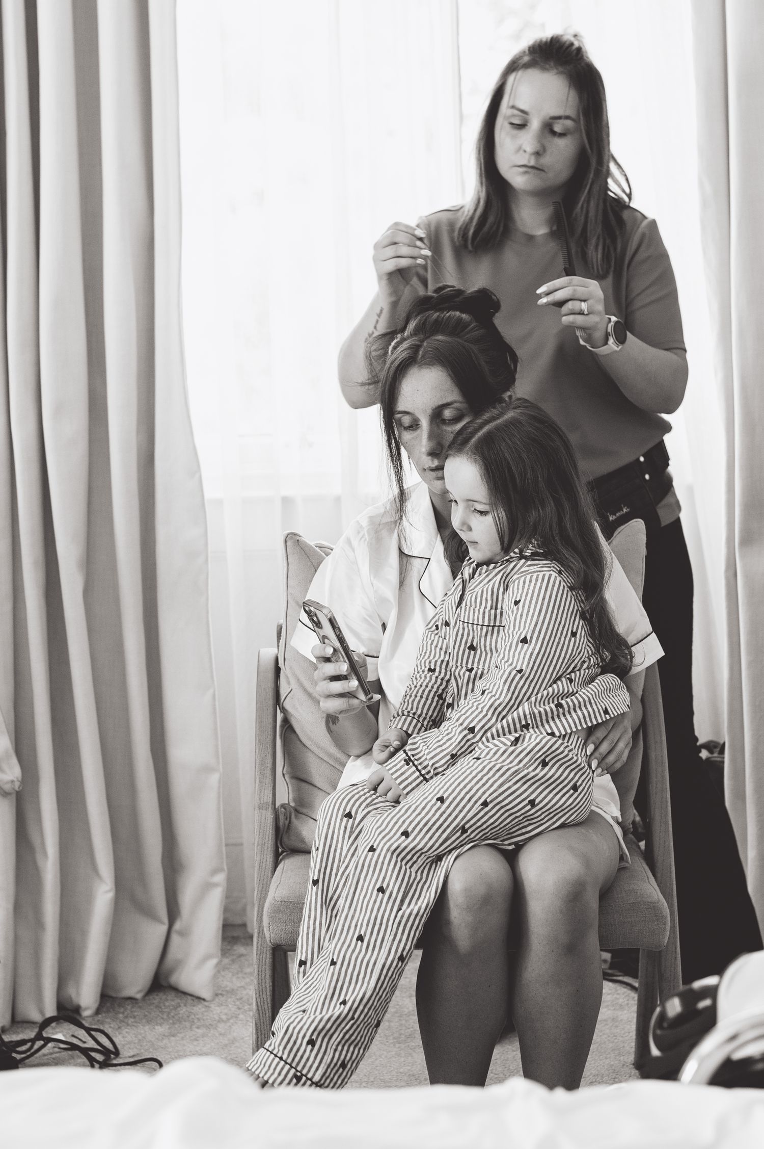Black and white image of wedding morning preparations with styling session.