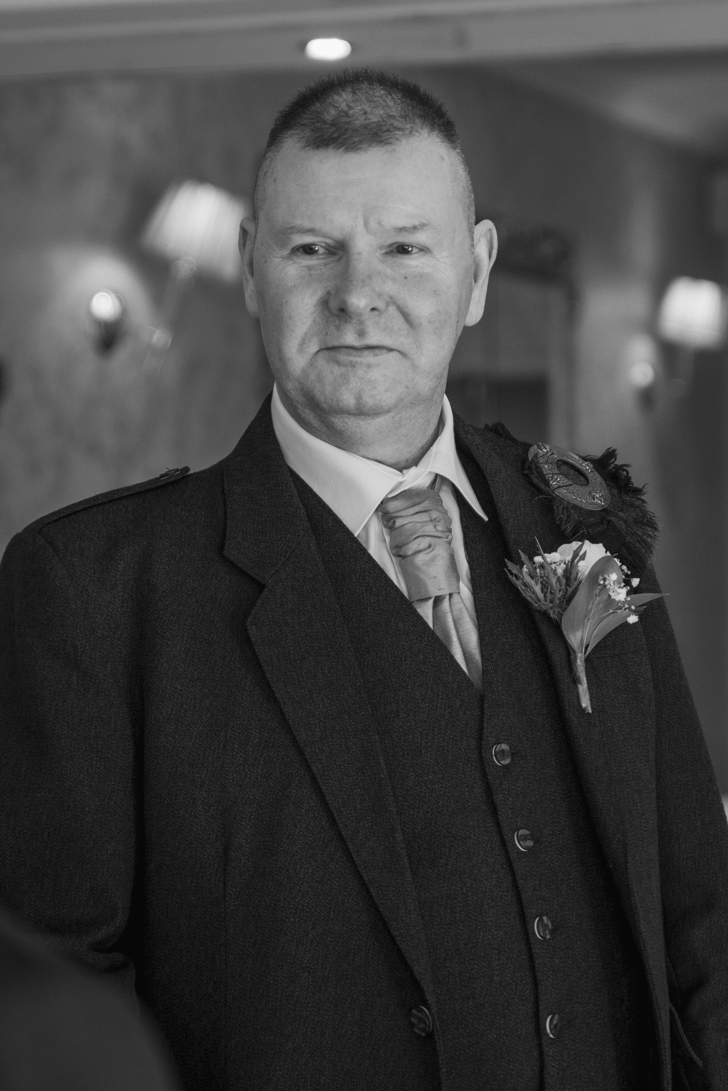 Black and white portraits showing formal attire at a wedding event.