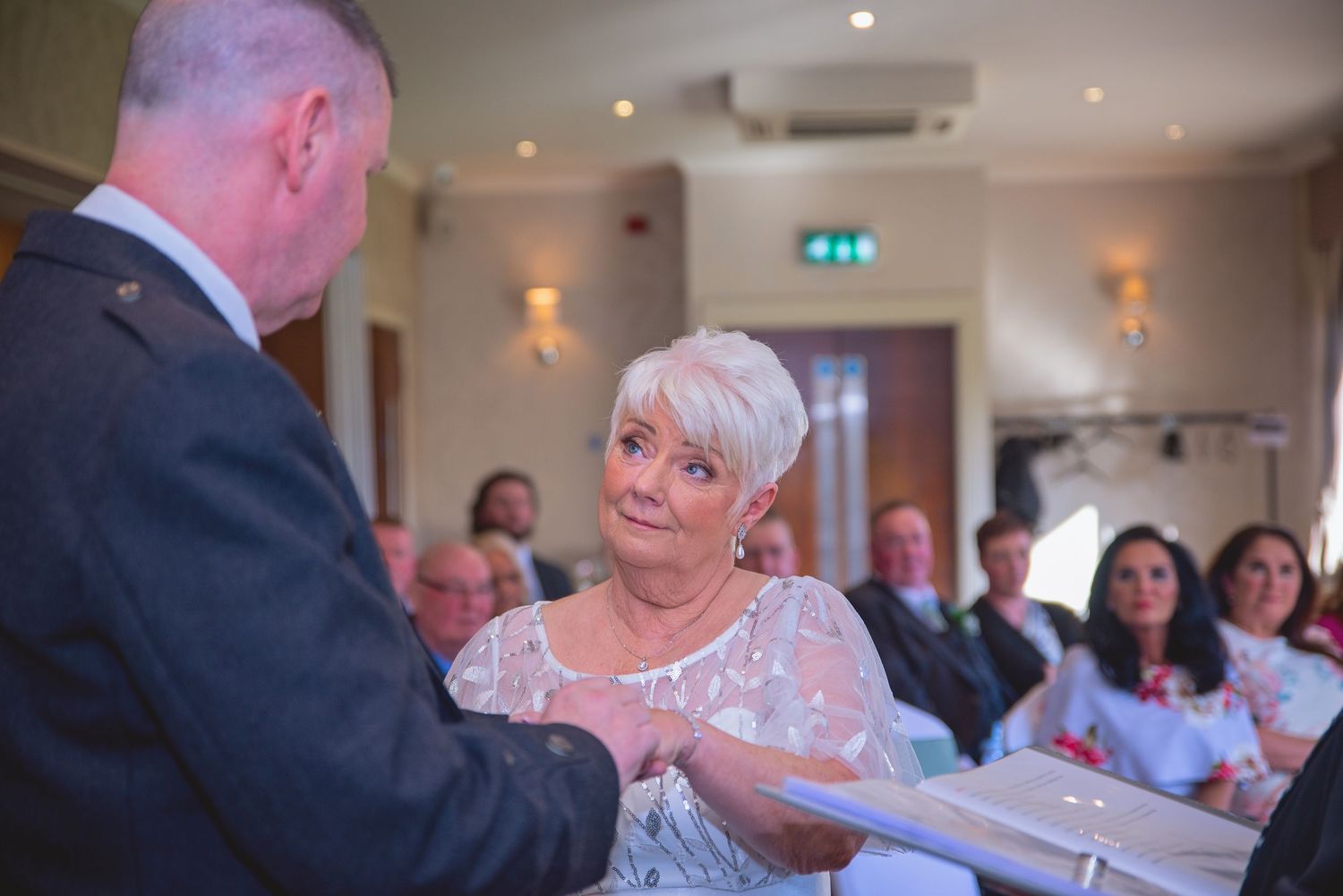 An intimate moment during a wedding ceremony as rings are exchanged.