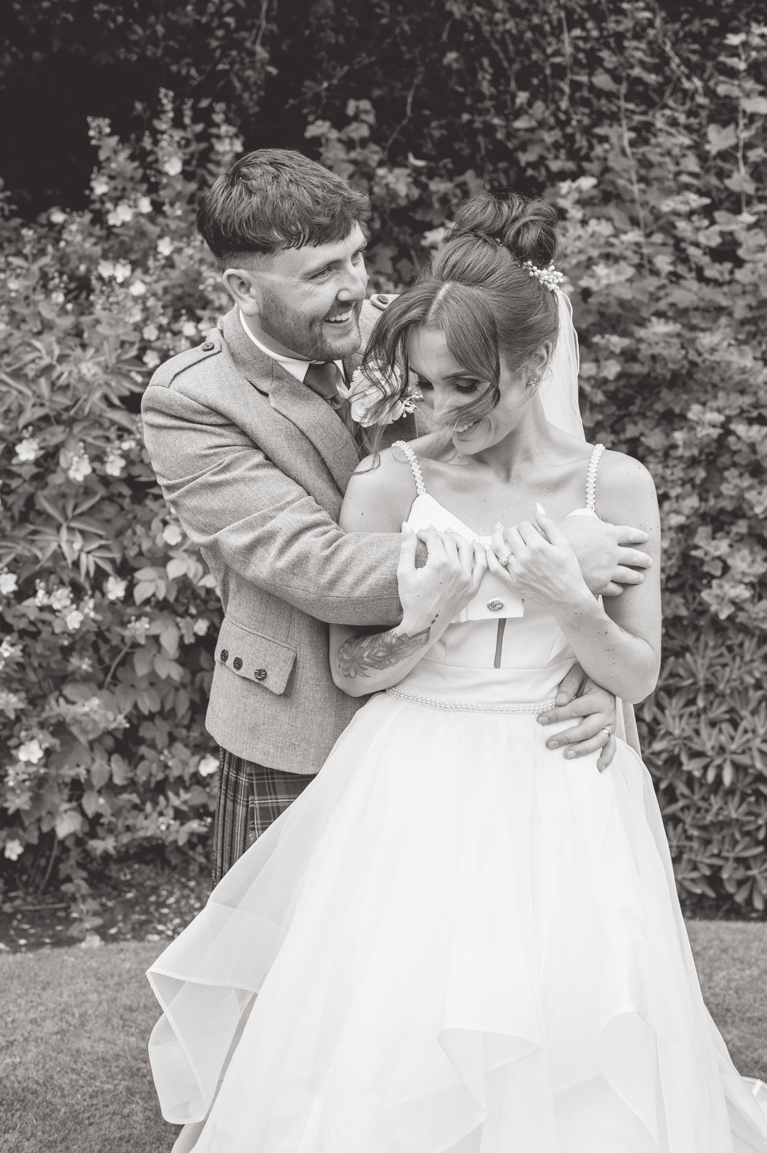 Candid black and white photos capturing joyful laughter between newlyweds.