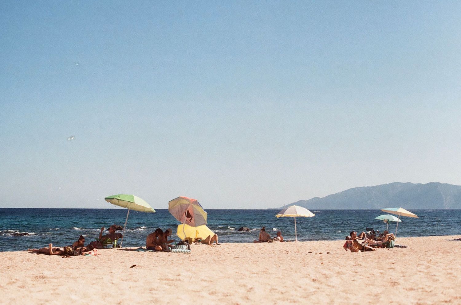 Capturing relaxing beach days and umbrellas on film.