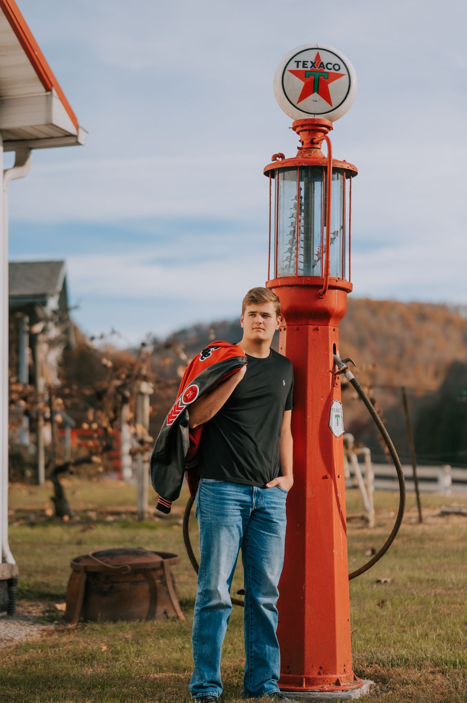 Portrait session at a vintage red Texaco gas pump station during golden hour.