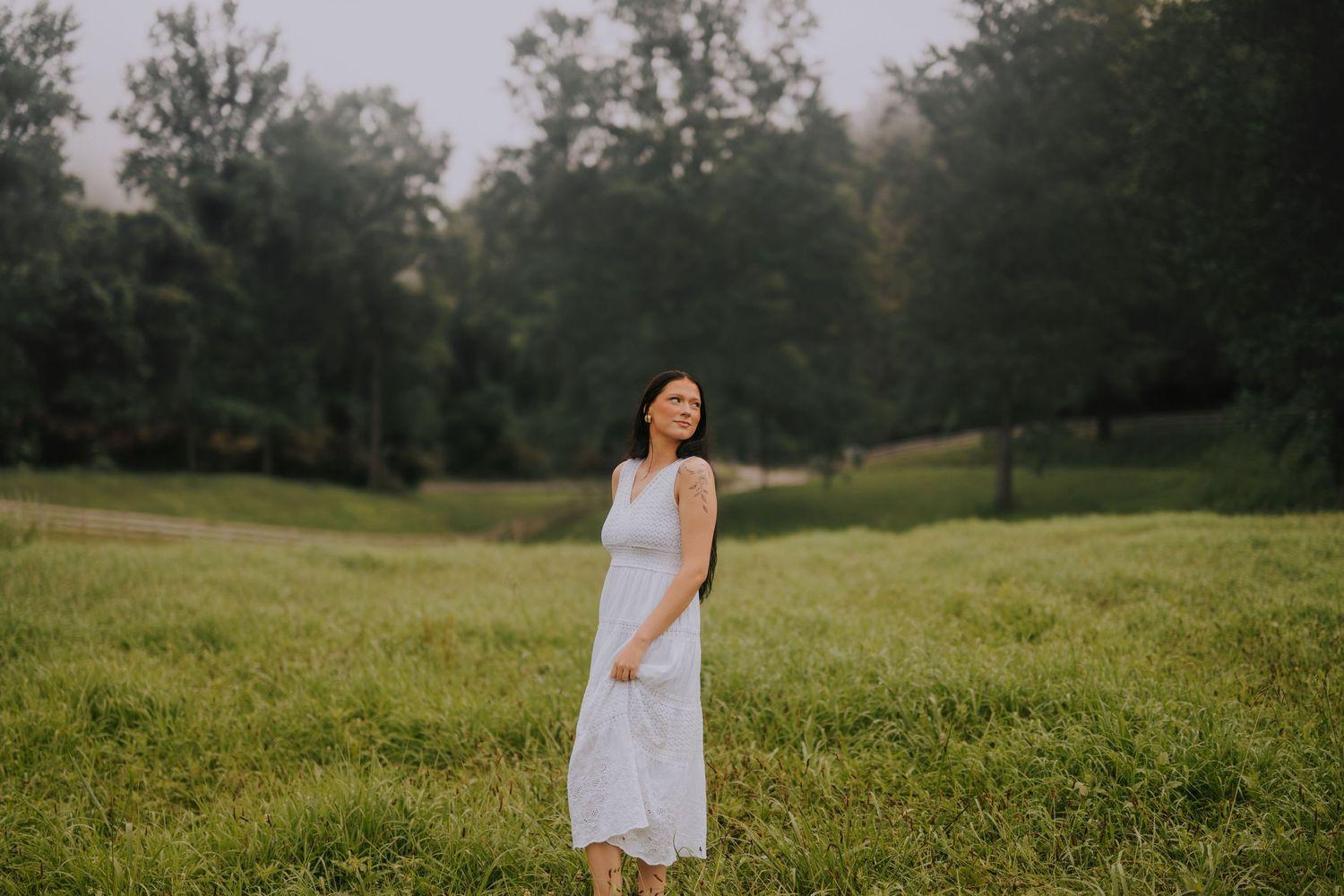 A dreamy summer scene with a white dress against a misty field backdrop.