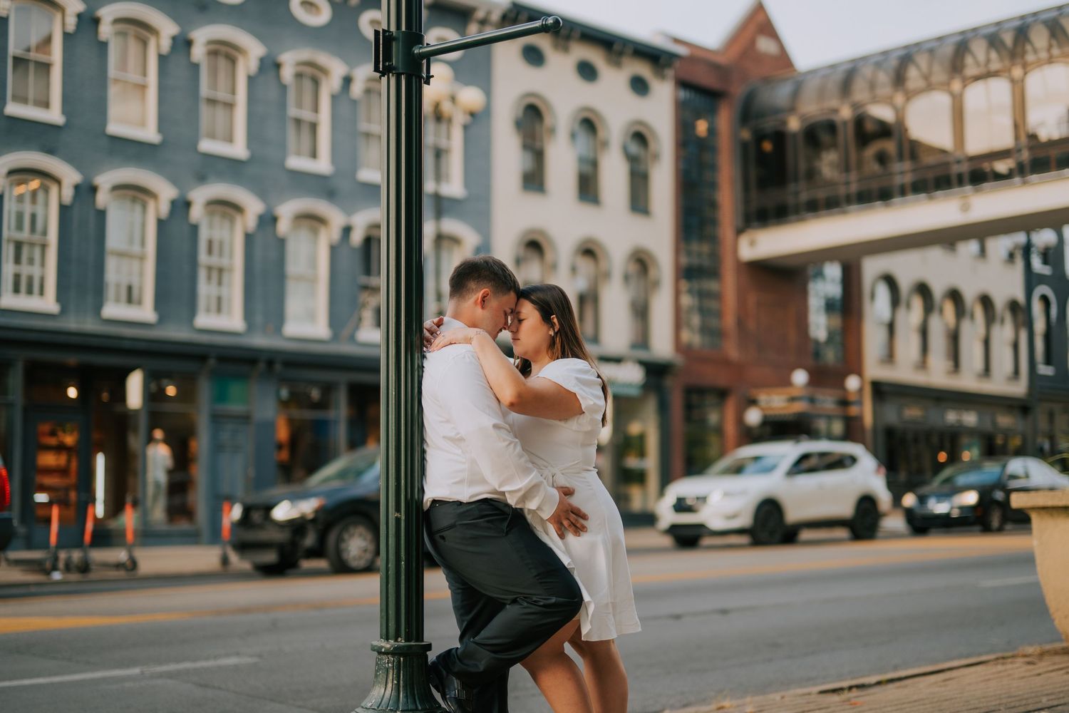 A series of romantic photos captured on a historic downtown street with brick buildings.