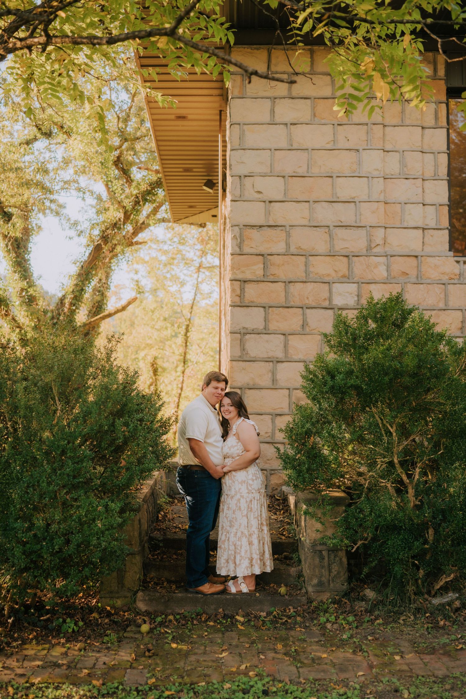 A romantic outdoor photoshoot series against a brick wall with greenery and natural lighting.