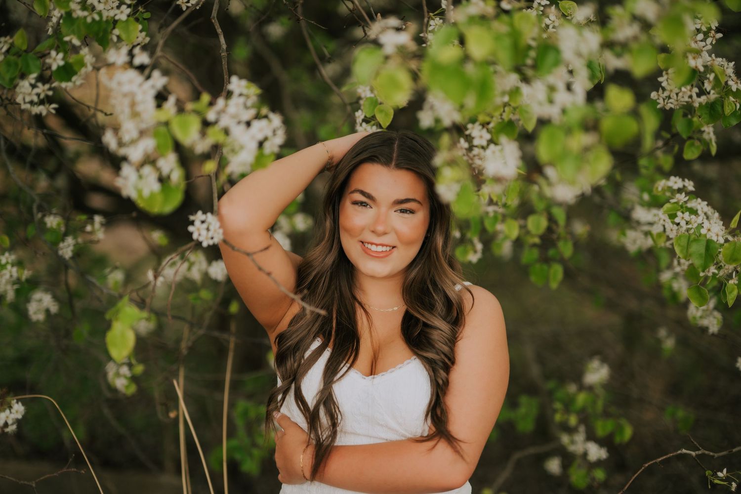 Spring portrait with blooming white flowers in natural outdoor setting.