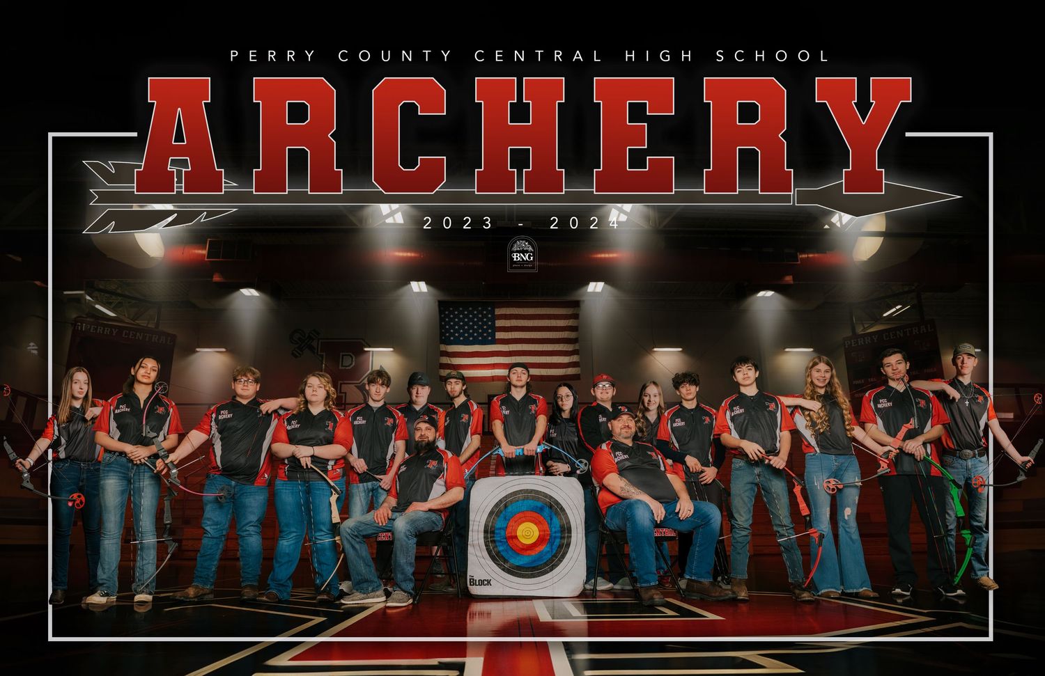 High school archery team poses together in front of targets for team photo with American flag.