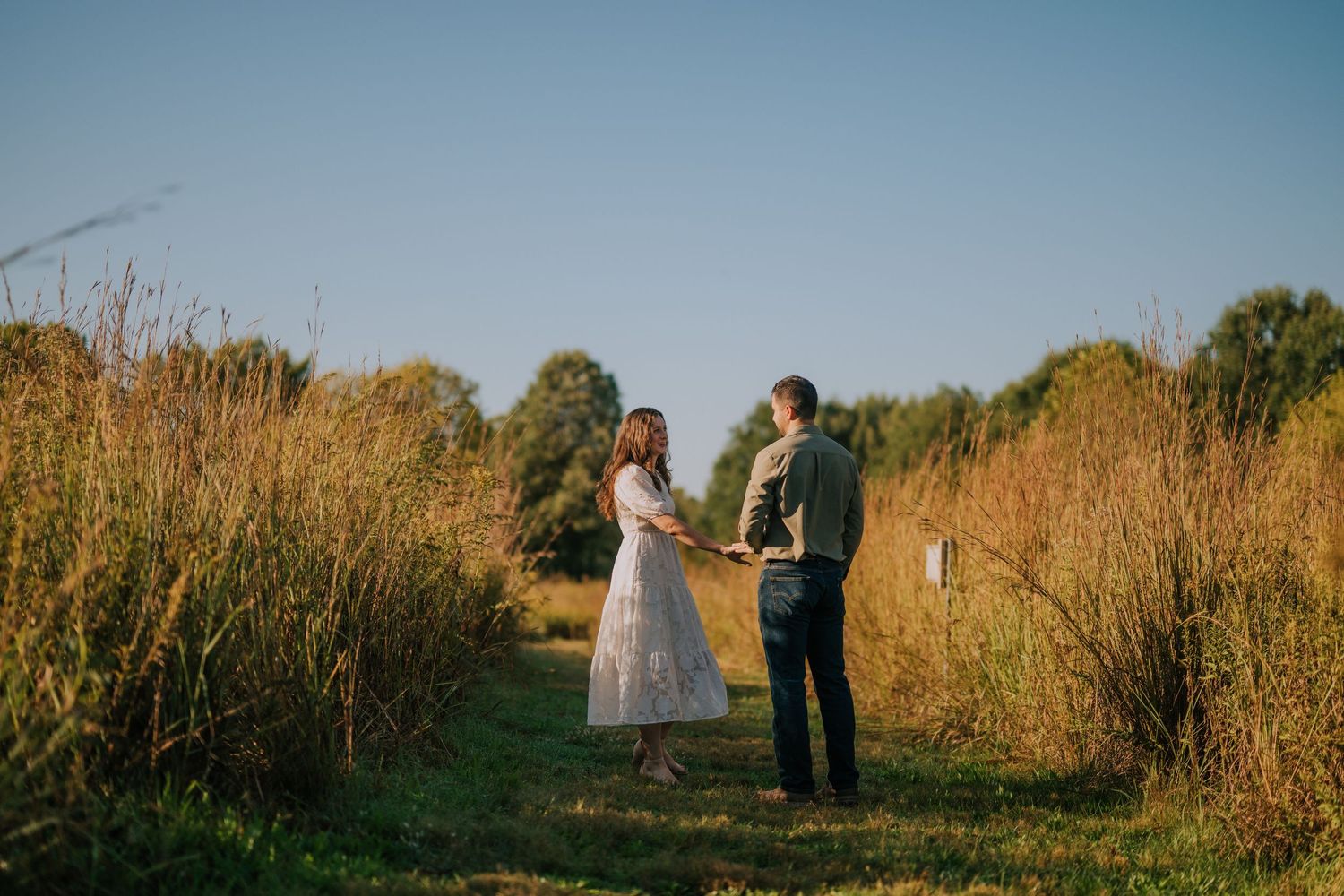 A series of intimate portraits captured in a golden field during sunset.
