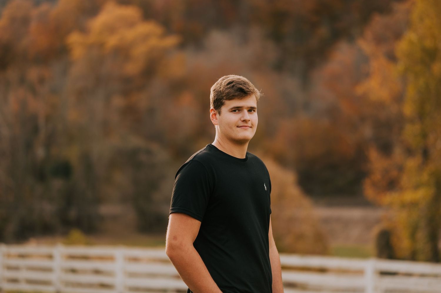 Outdoor portrait series in autumn featuring casual black t-shirt against fall foliage.