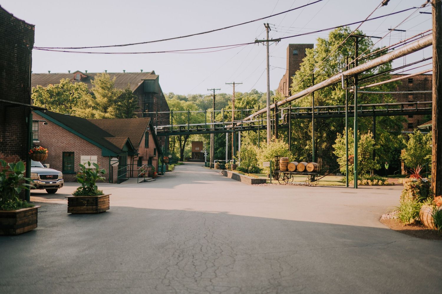 Long panoramic view of an industrial warehouse complex with brick buildings and walkways.