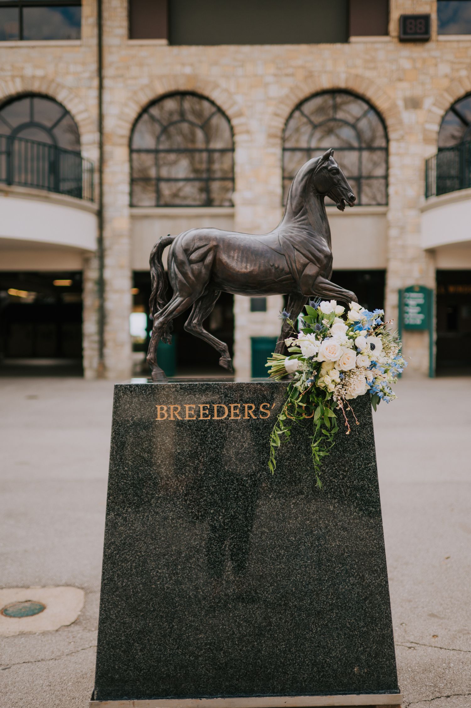 Bronze horse statue with floral arrangement at the Breeders monument.