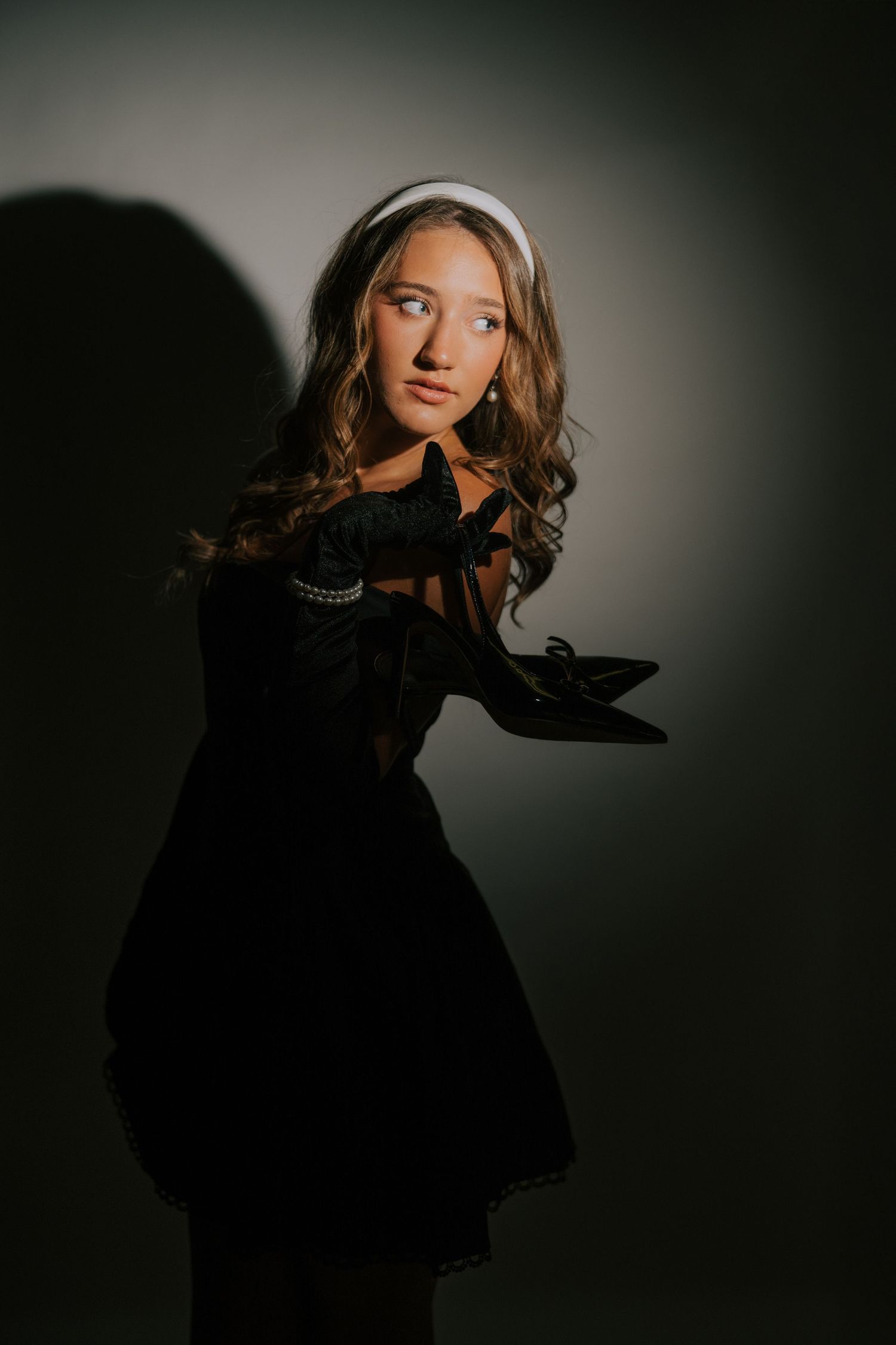 Artistic portrait series in dramatic lighting against dark background.