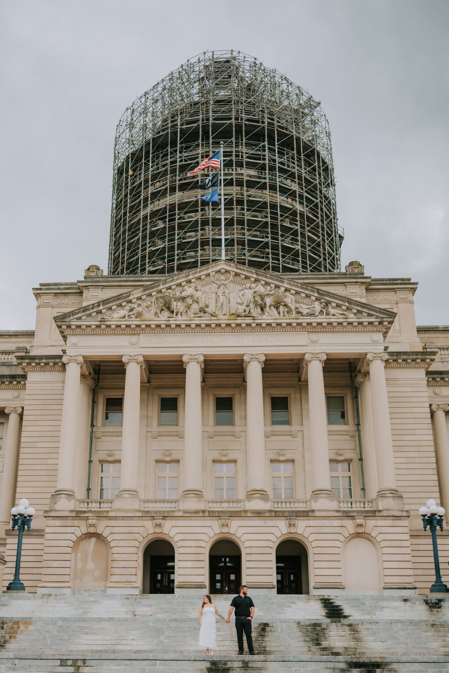 A historic building with scaffolding on its dome and classical architectural features.