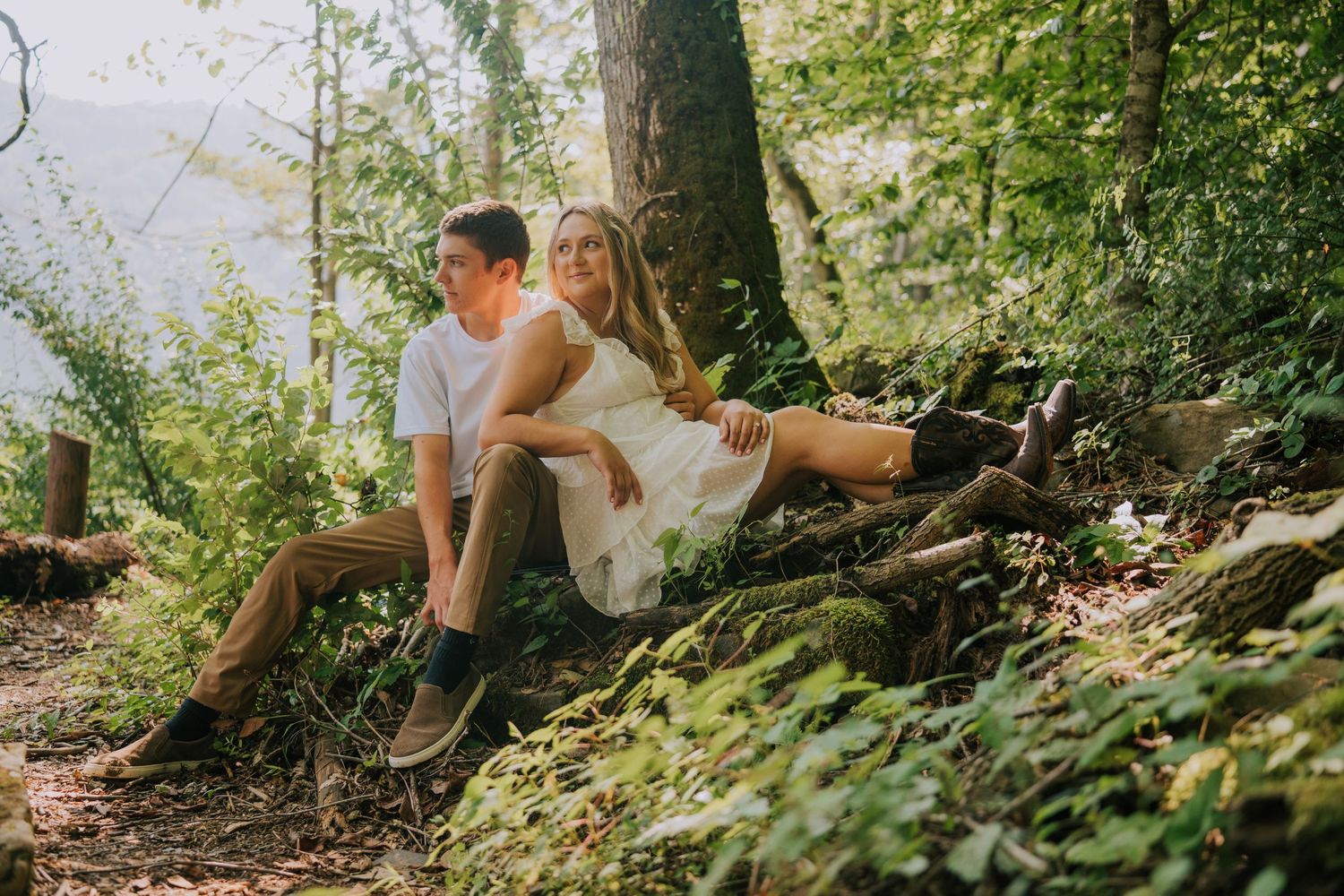 Romantic woodland photo session with couple among trees and greenery.