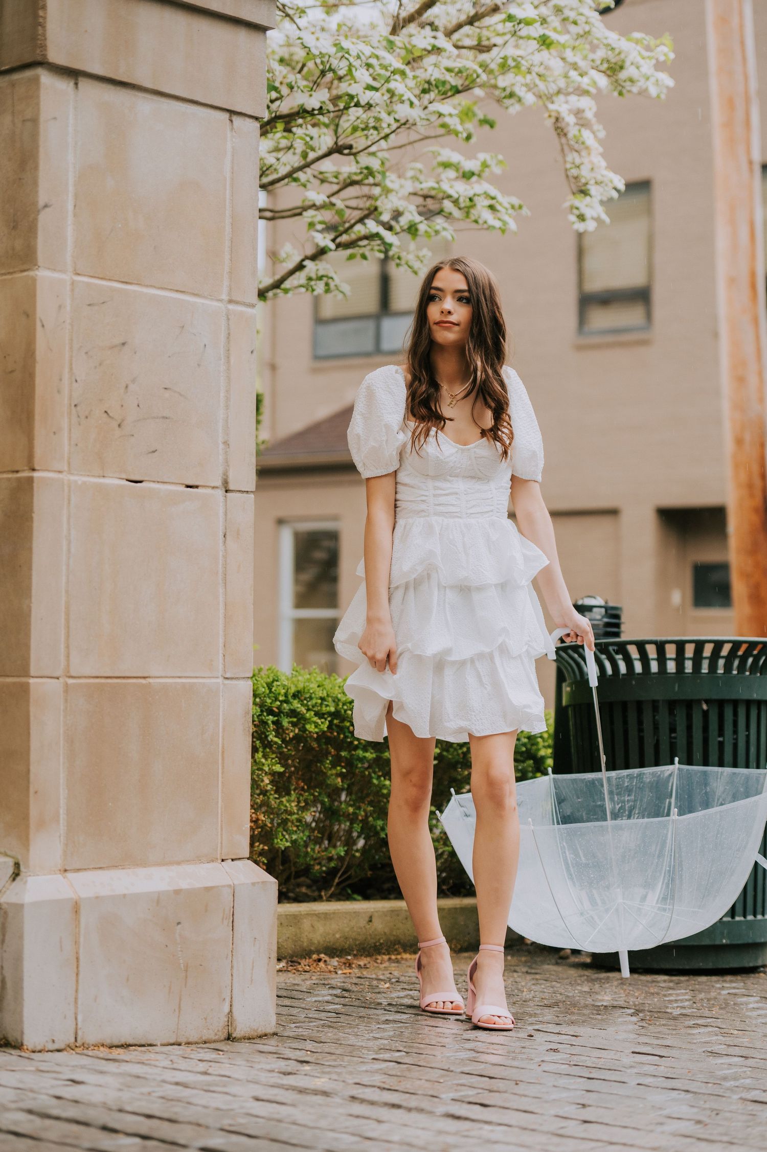 A sequence of white dress photos captured between stone pillars in an urban setting.