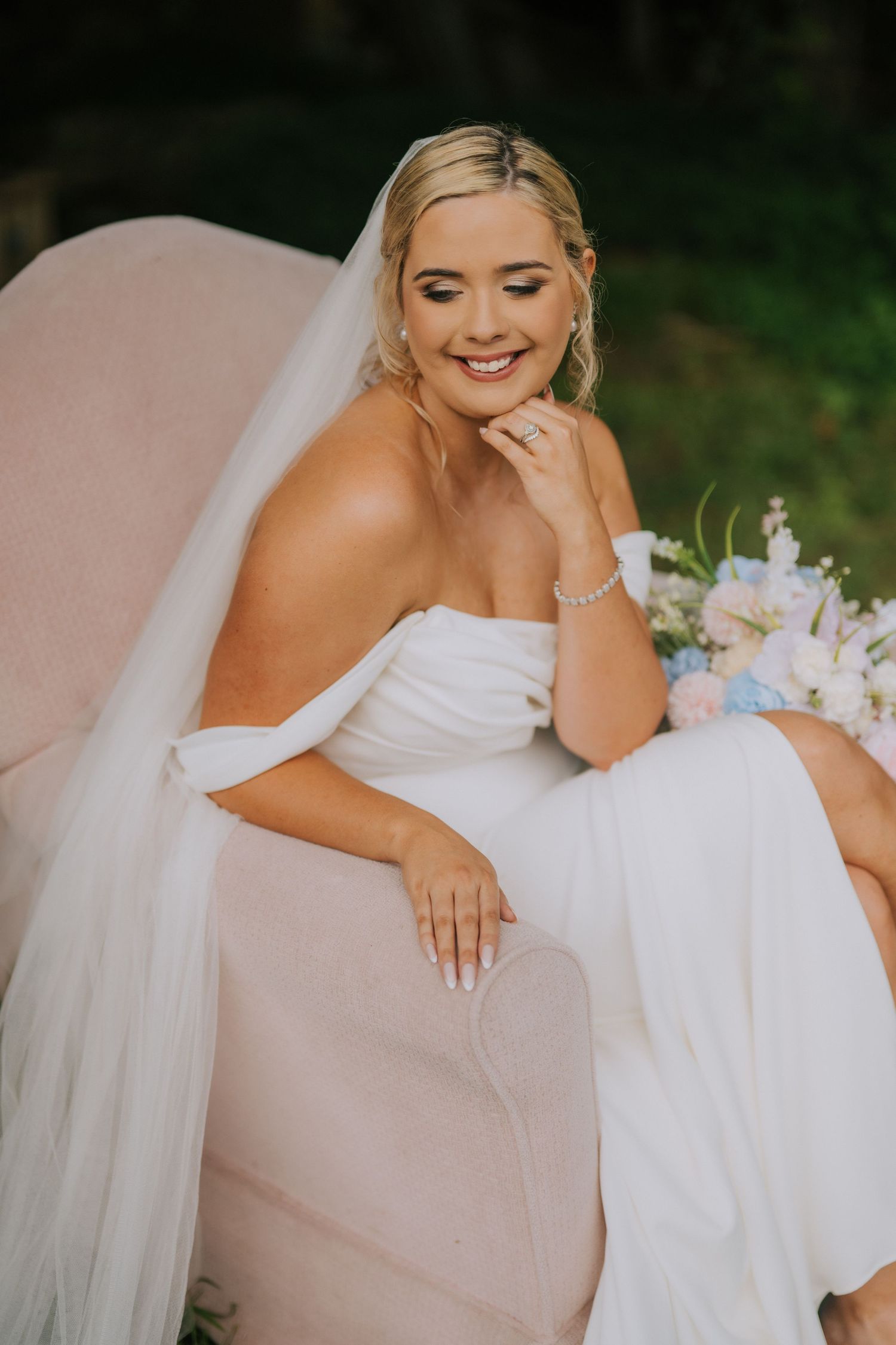 Close-up shots of a bride in a white wedding dress with delicate details and flowing veil.