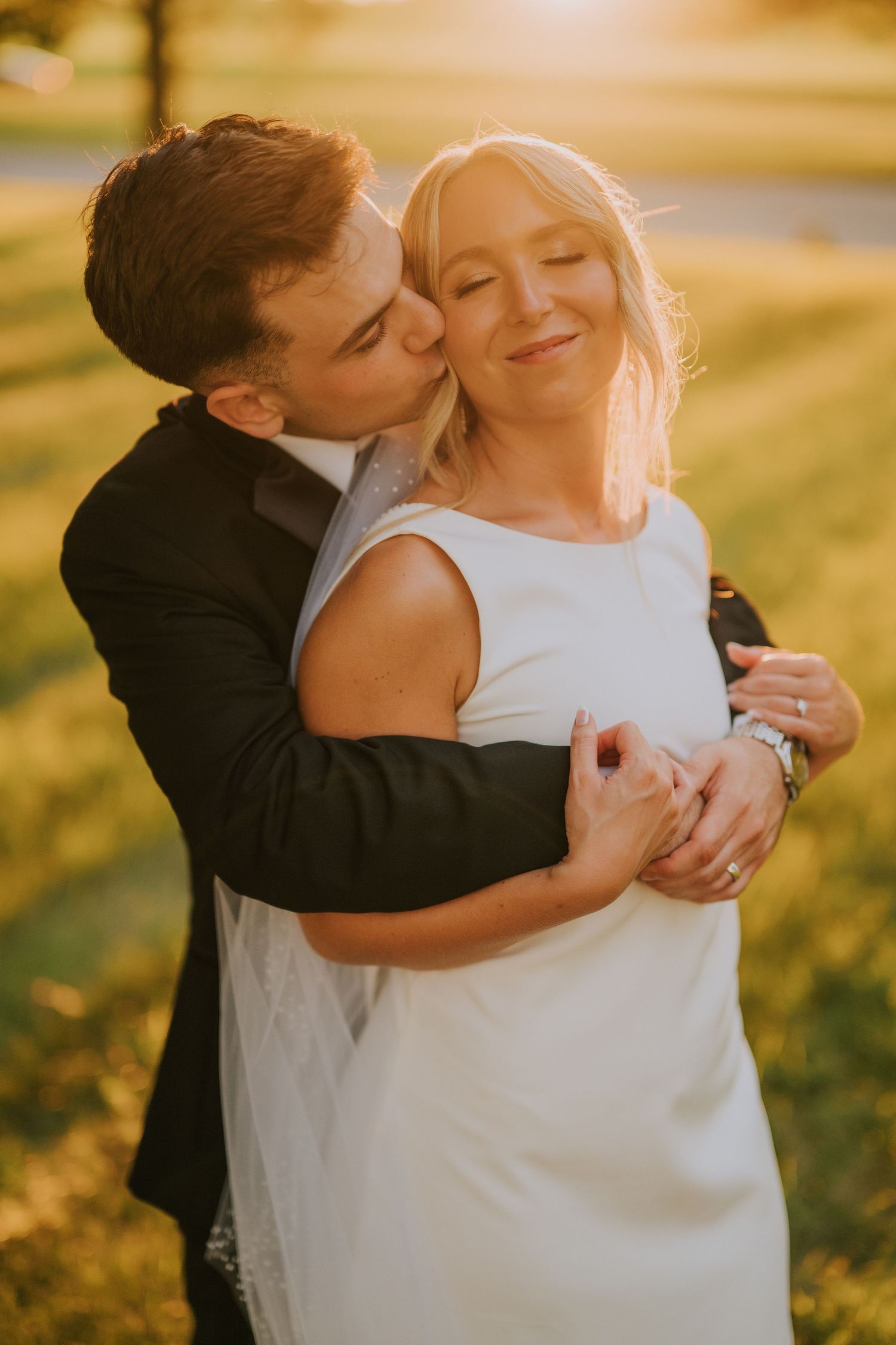 Golden hour wedding portraits with warm sunlight and tender moments.