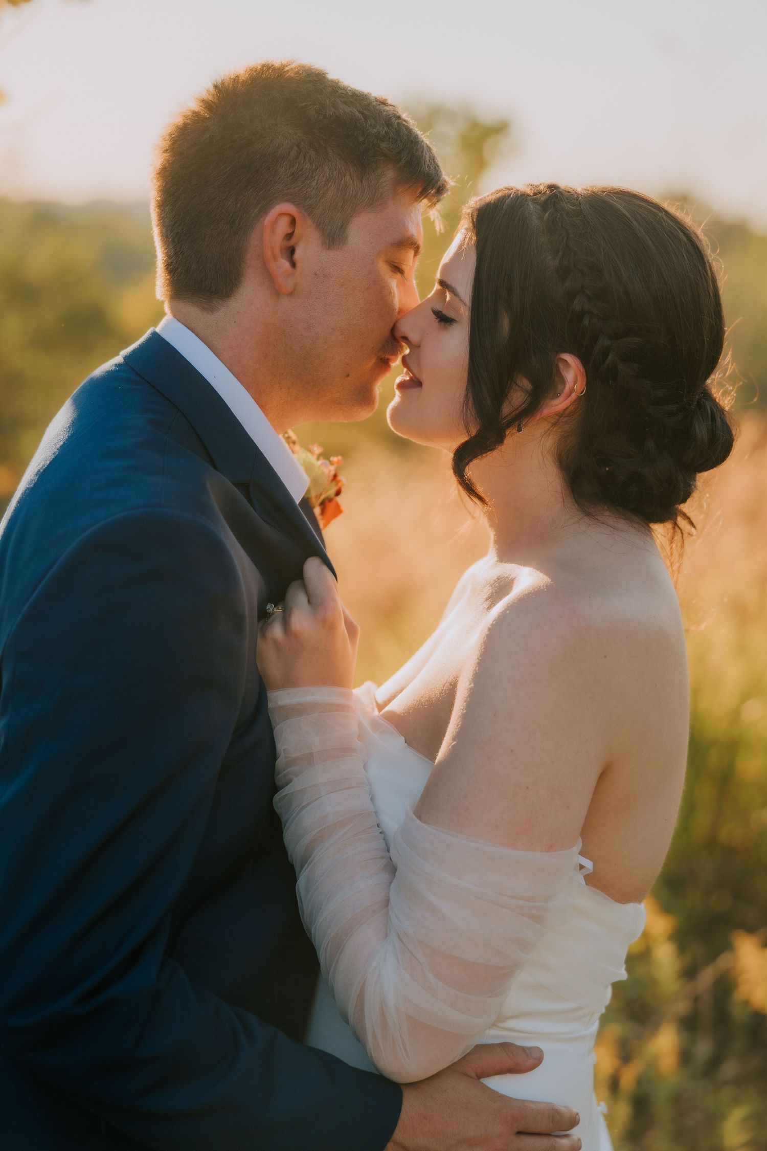 Romantic wedding couple sharing intimate kisses in a series of golden hour portraits against a soft sunset backdrop.