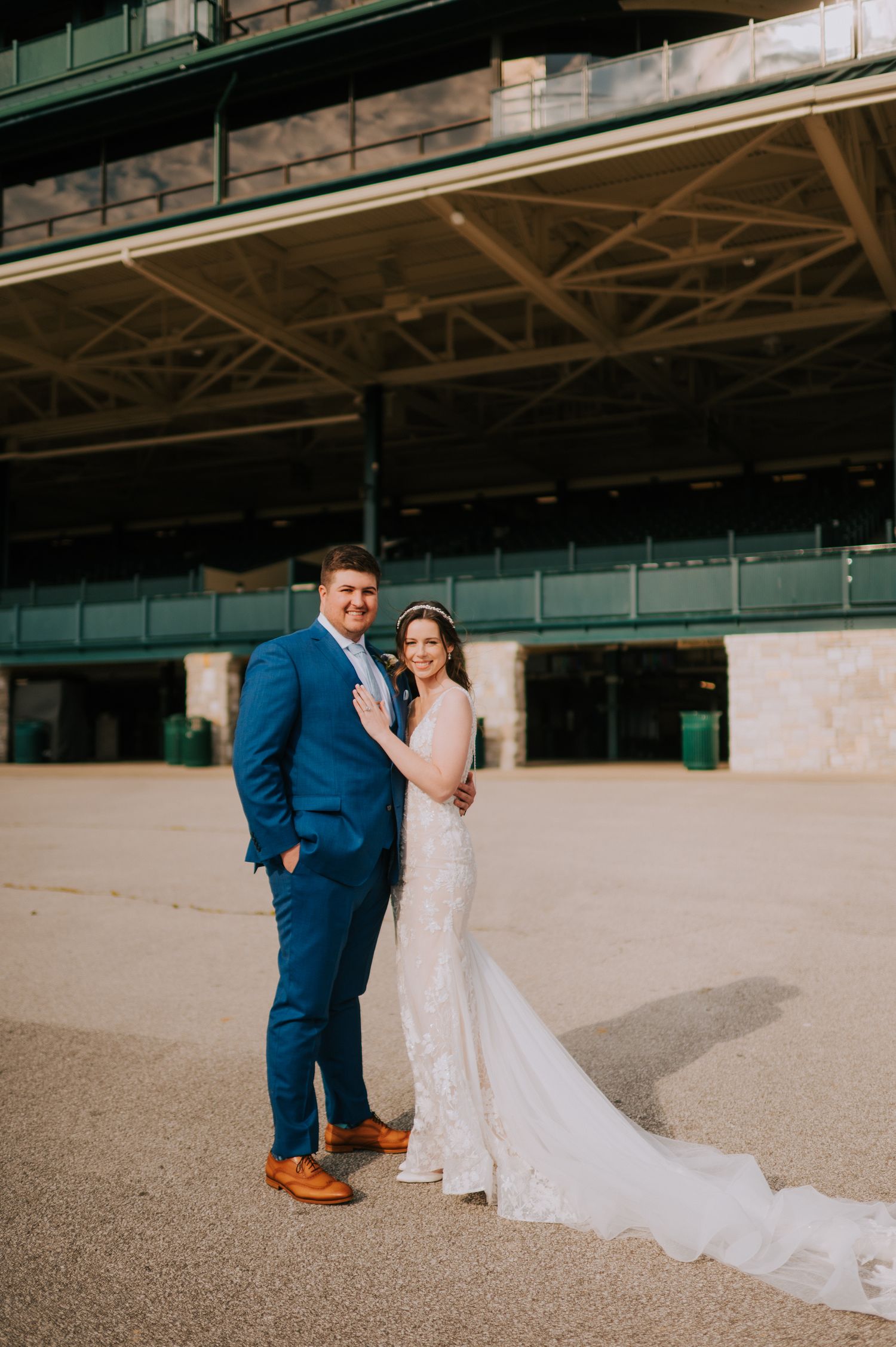 A wedding photo taken at a historic venue featuring formal attire and a flowing white dress.