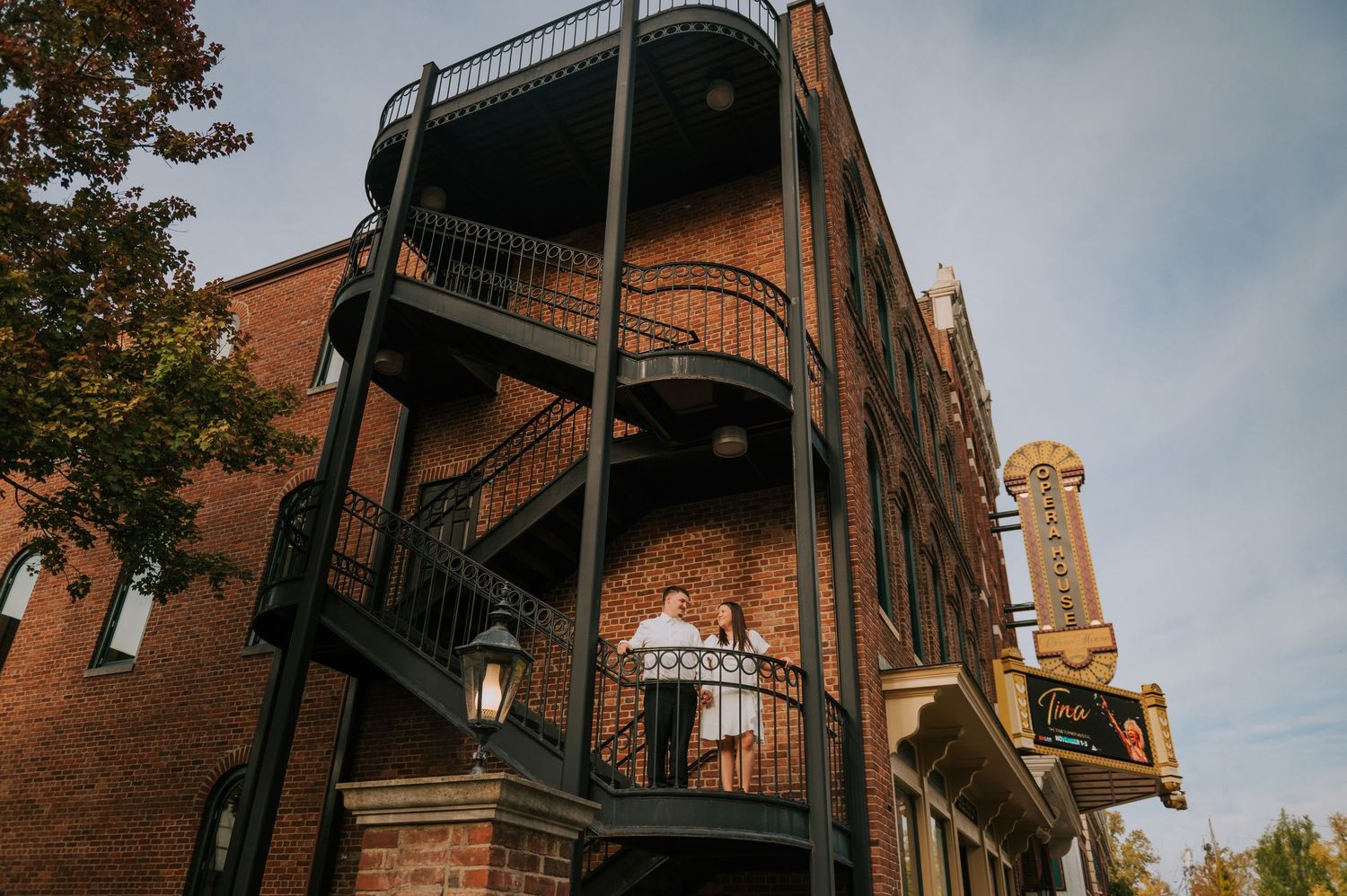 Historic brick buildings with ornate iron fire escapes and architectural details.