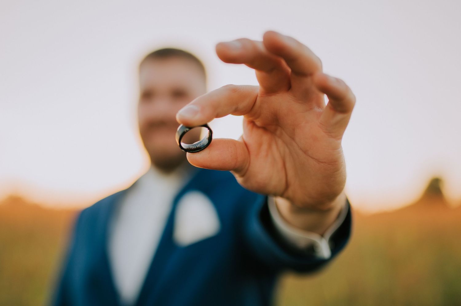 Close-up of wedding rings being displayed against a bright background.