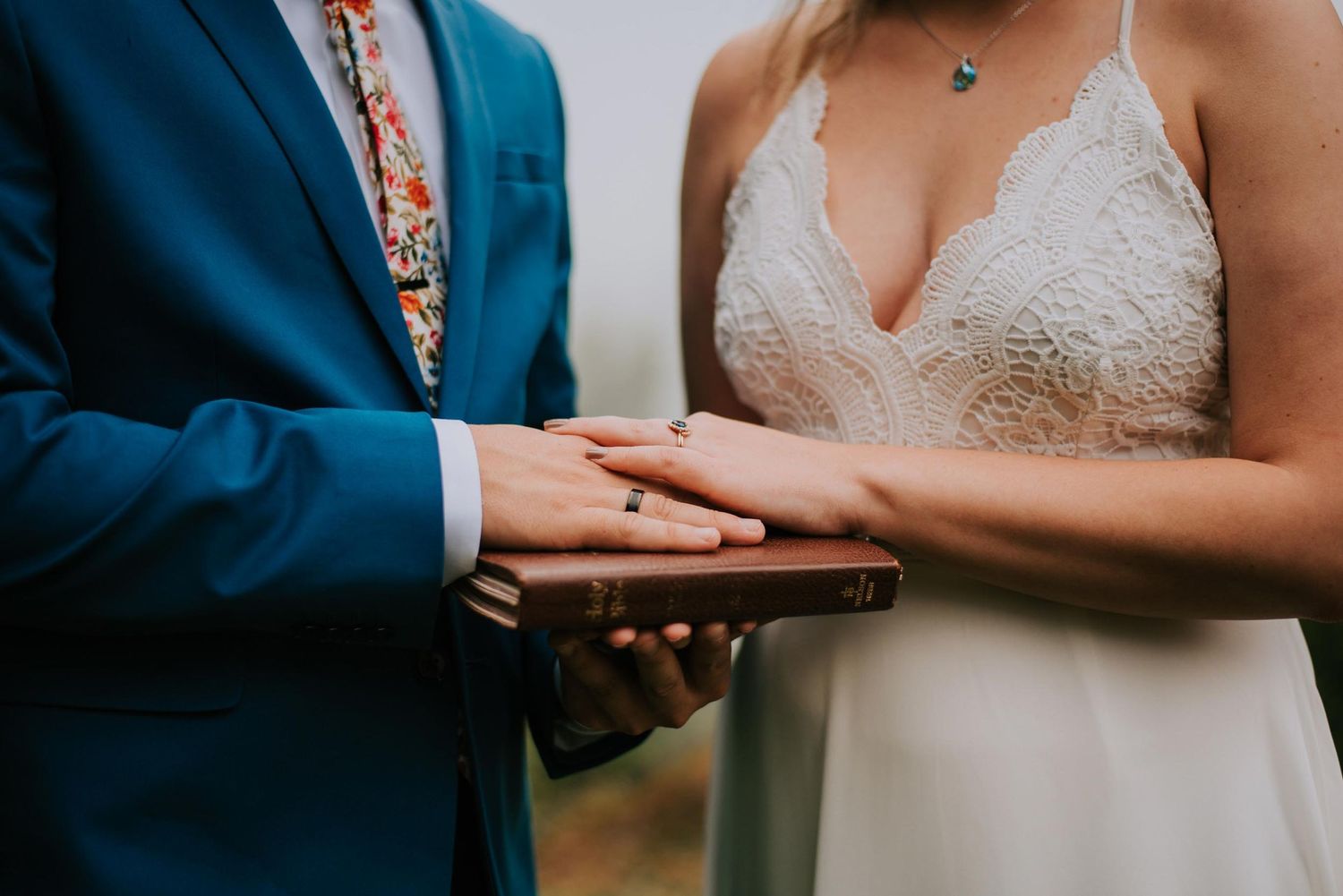 Close-up details of formal attire and hands during an intimate moment.