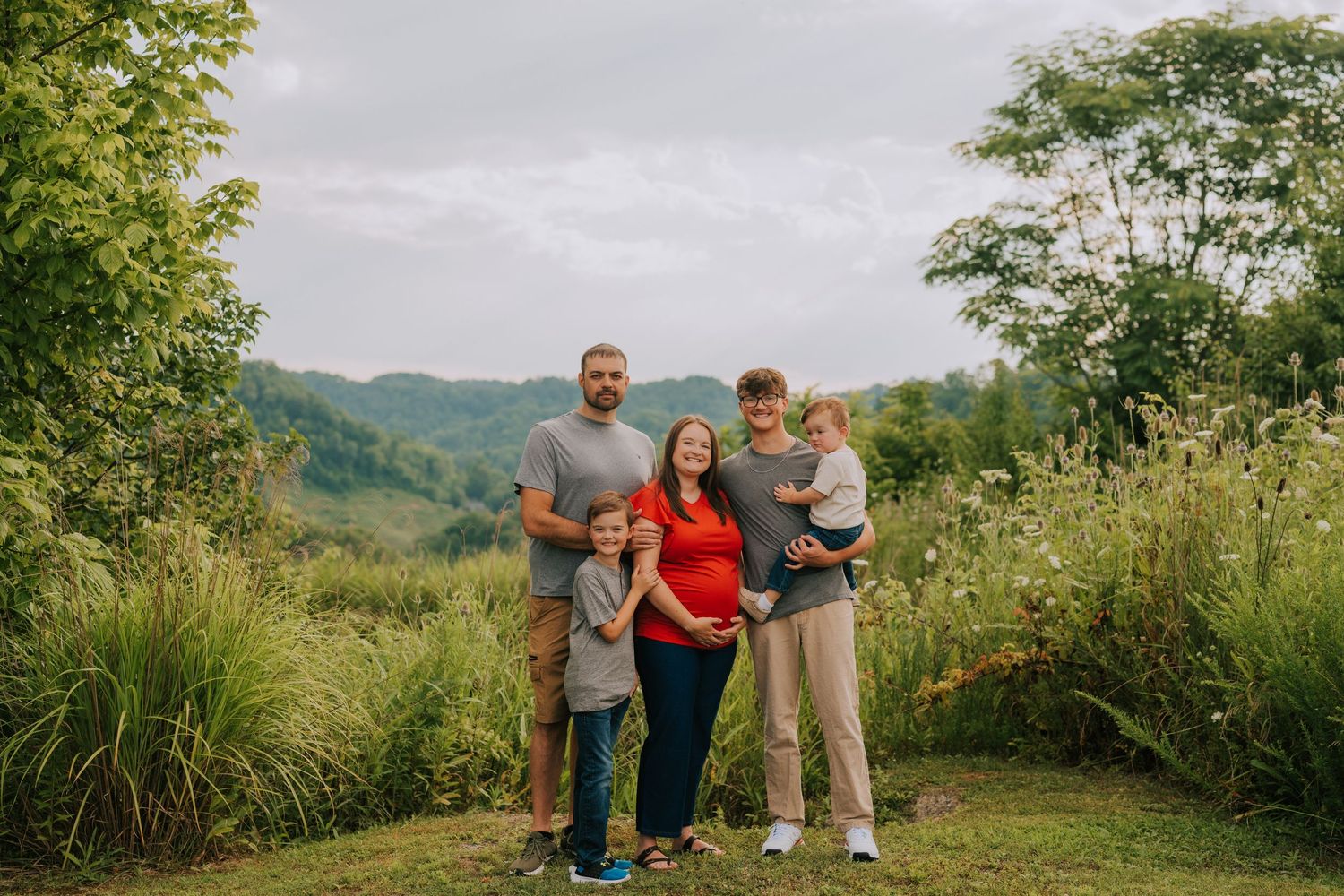 Group enjoying a scenic mountain overlook on a summer day.