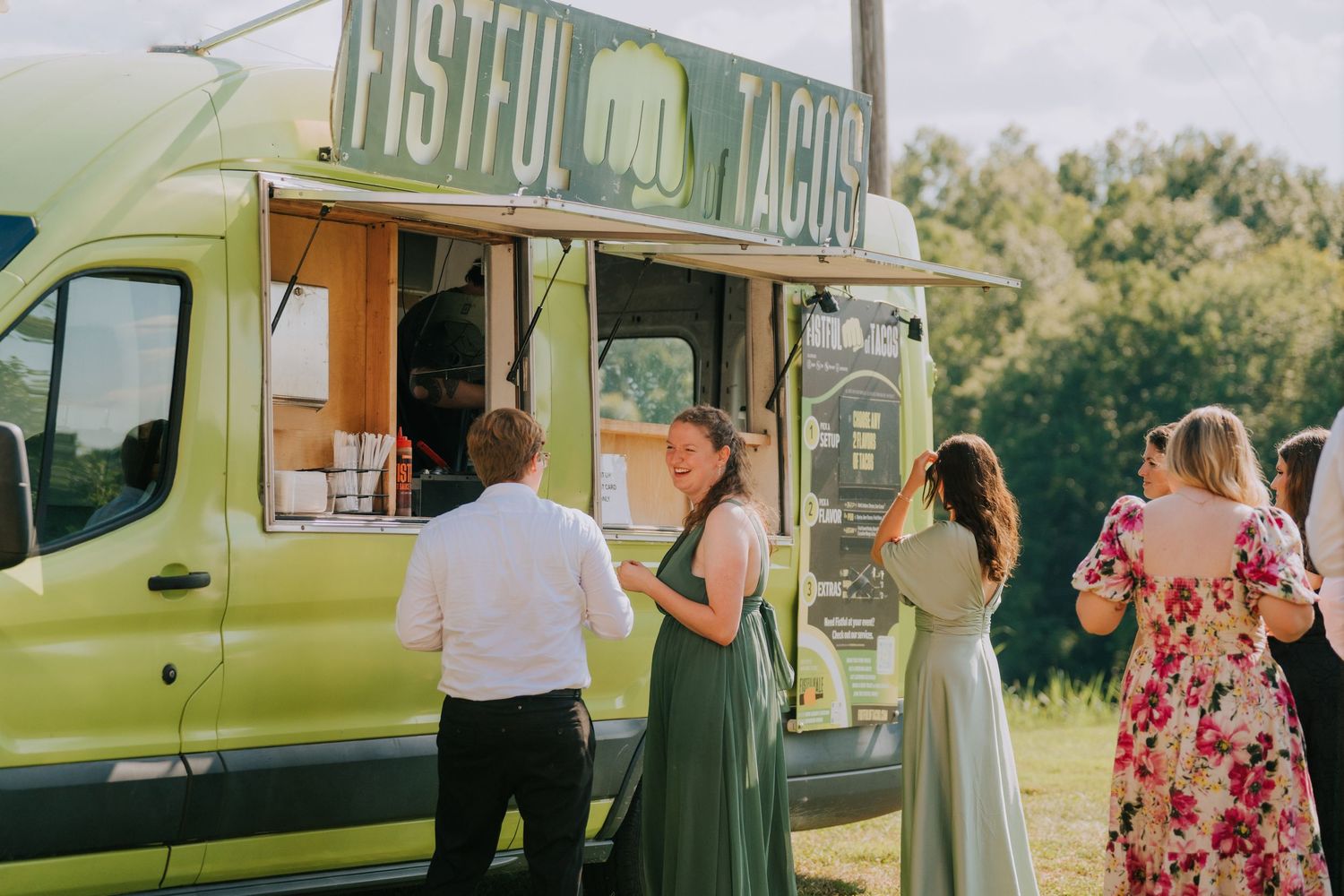 Food truck serves guests at an outdoor wedding celebration.