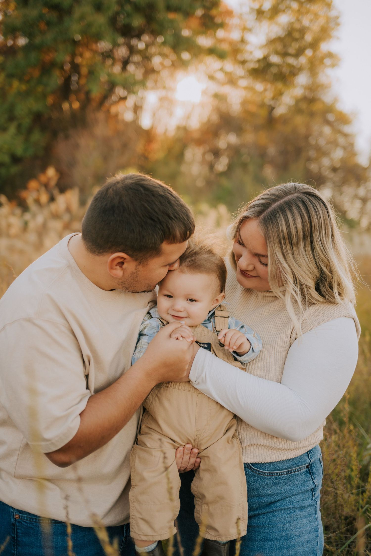 Family sharing intimate moment together outdoors during golden hour photoshoot.