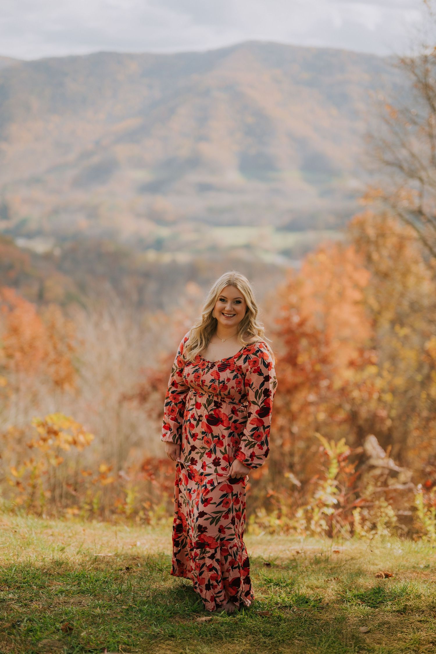 Rolling mountains create a scenic backdrop against an autumn landscape.