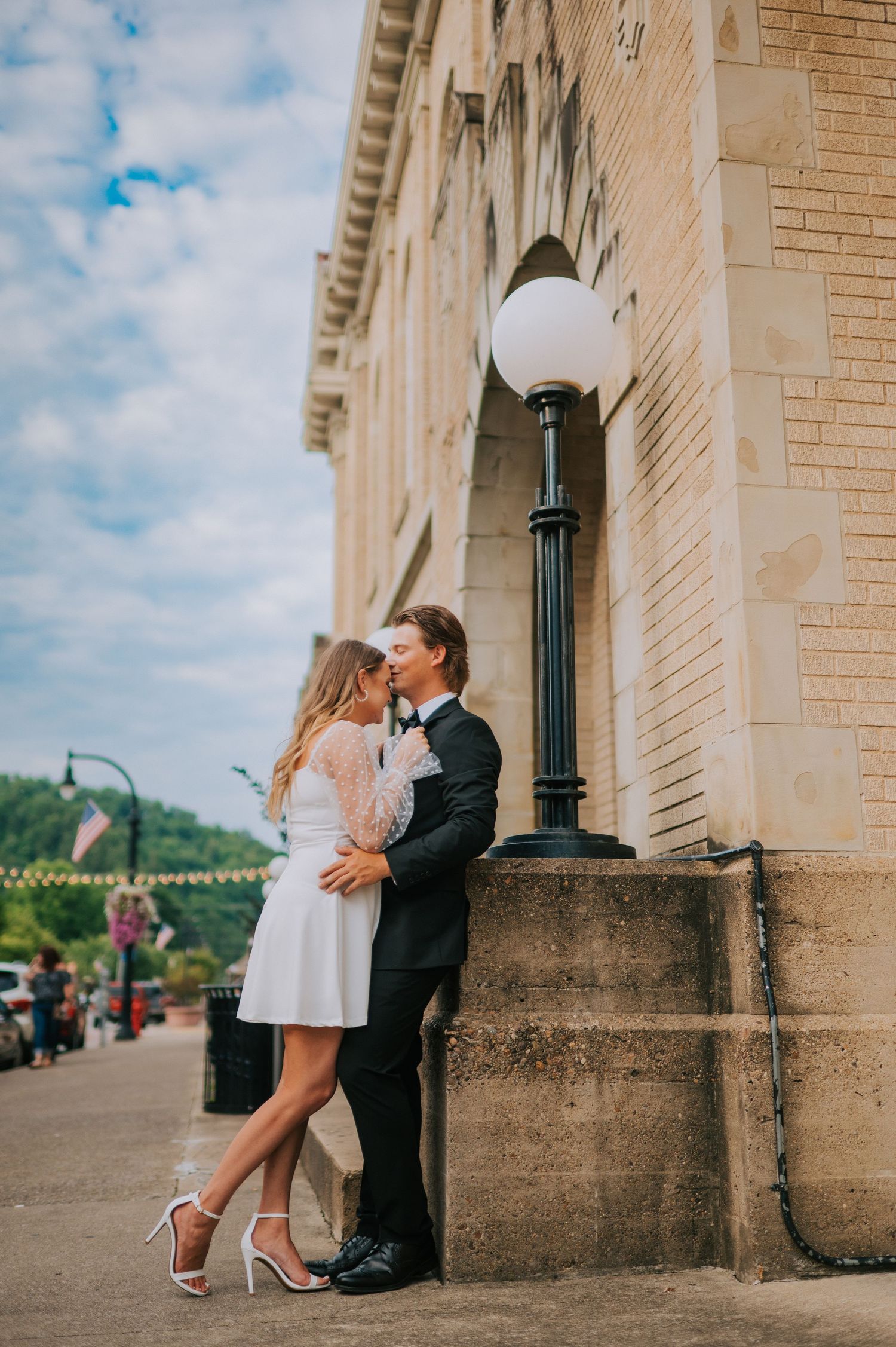 A romantic moment captured against the architectural backdrop of a historic building.