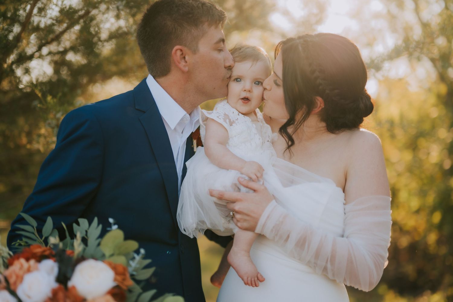 Romantic sunset wedding portraits in a golden field with soft natural lighting.