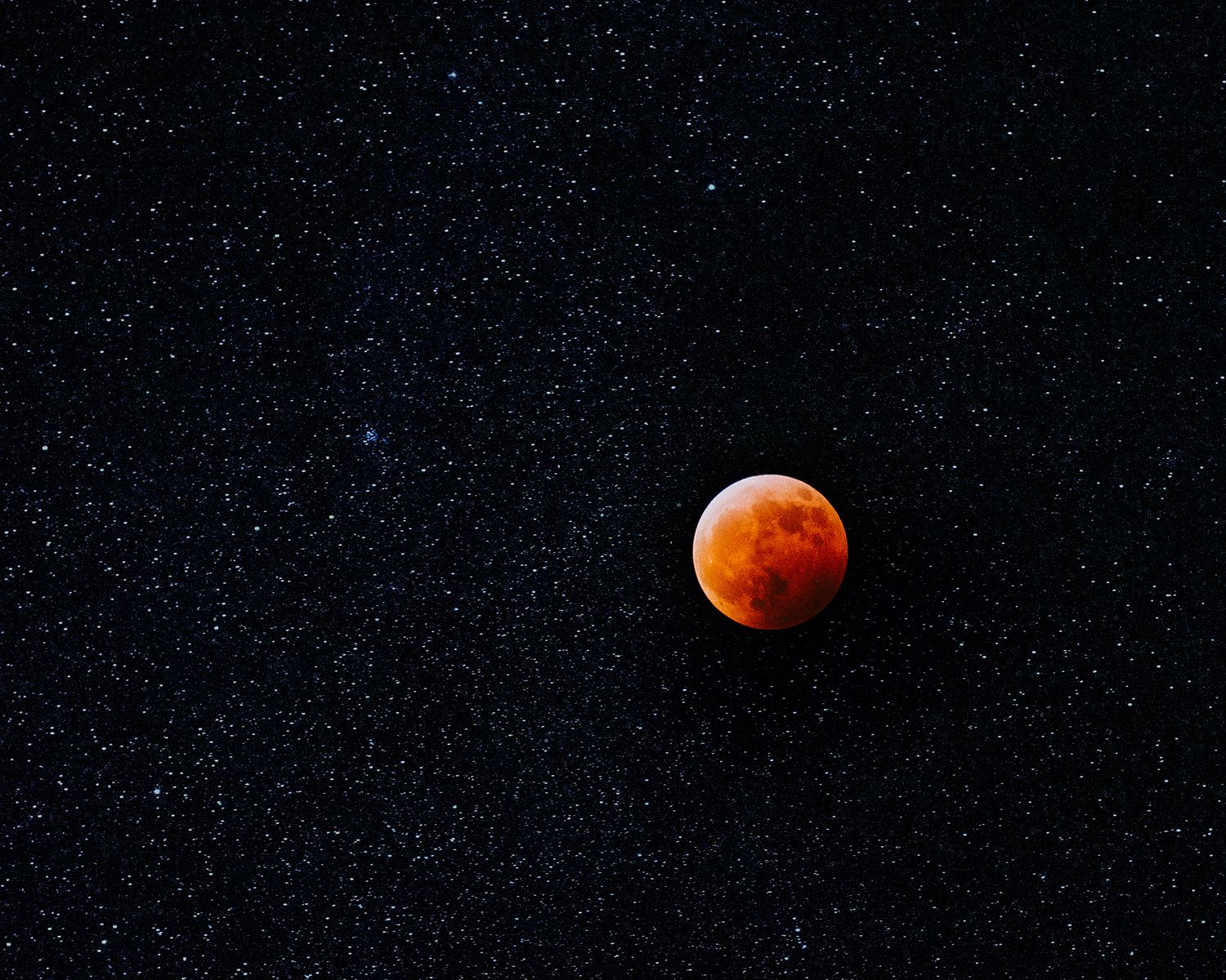 Series of photos showing phases of a blood moon eclipse against a dark night sky.