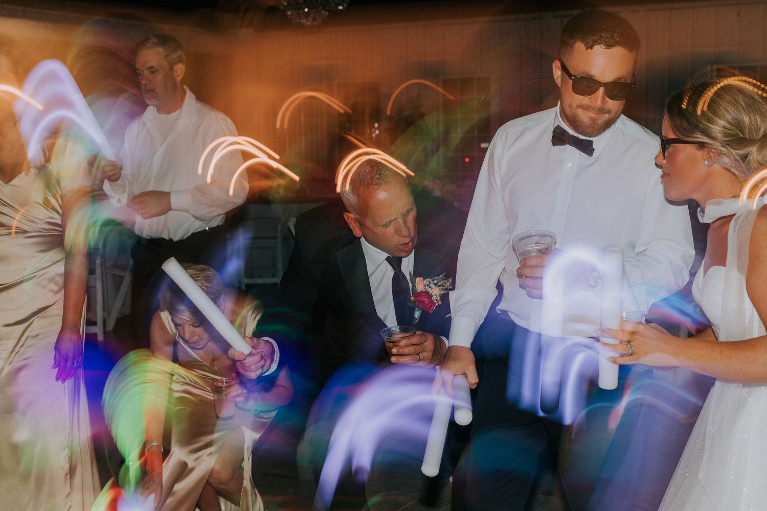 Wedding party dancing and celebrating together on the dance floor during a reception.
