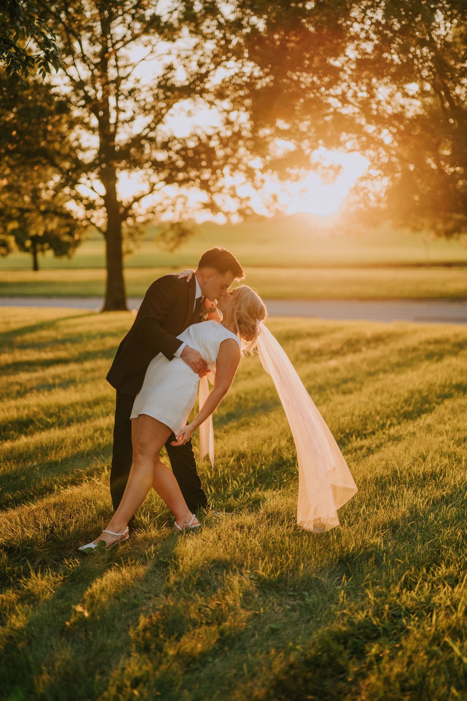 Romantic sunset wedding photos with dramatic lighting and dips.