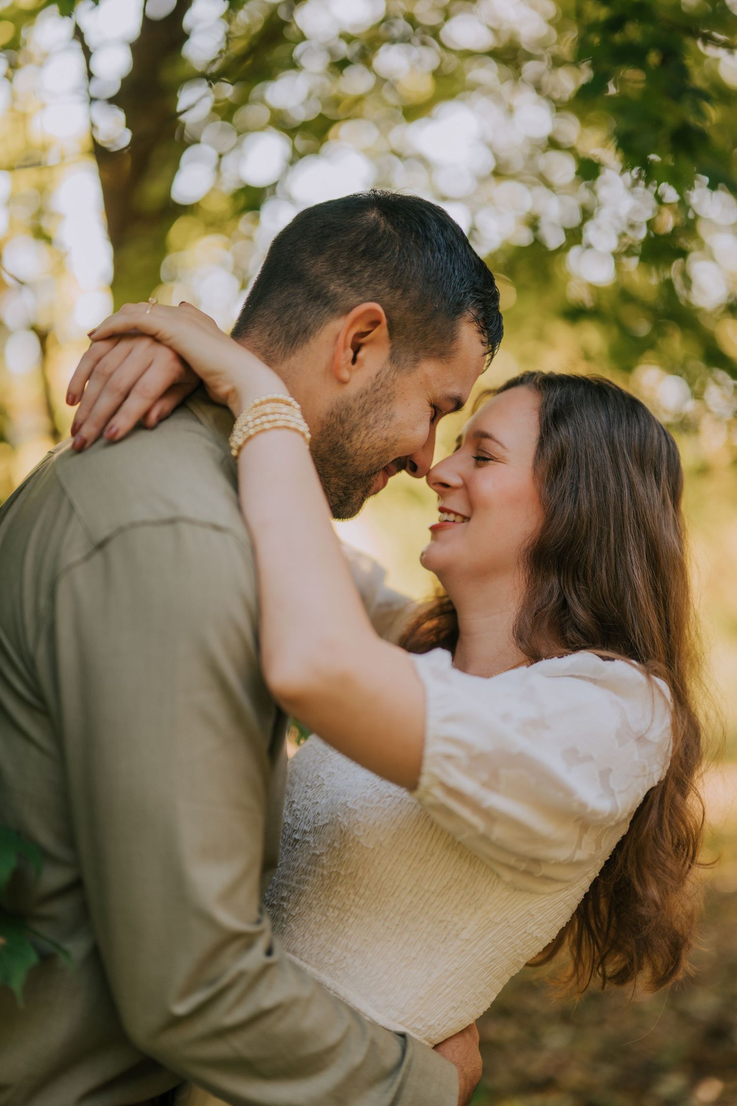 Romantic outdoor couple photography session with soft natural lighting and bokeh effect.