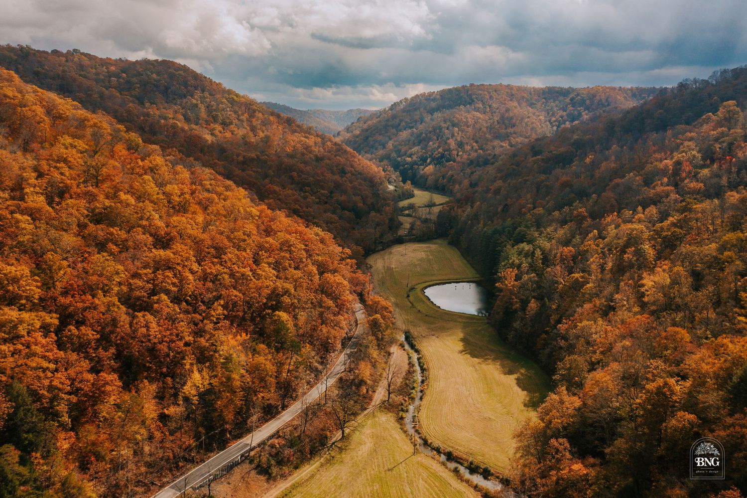 Sweeping autumn landscape of mountain valley with vibrant fall foliage.