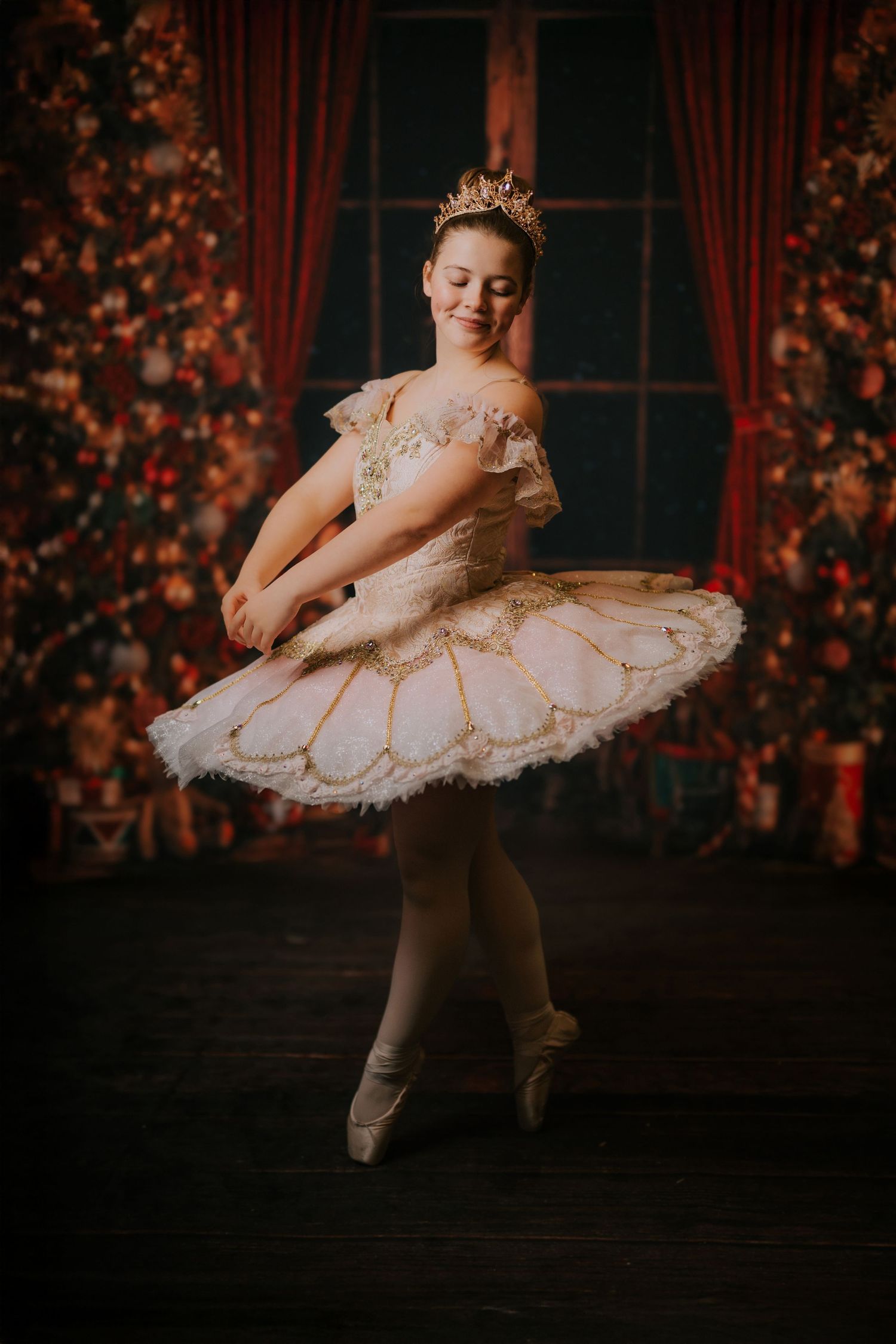 Ballet dancer in white and gold tutu performs graceful poses against dark backdrop with red floral accents.
