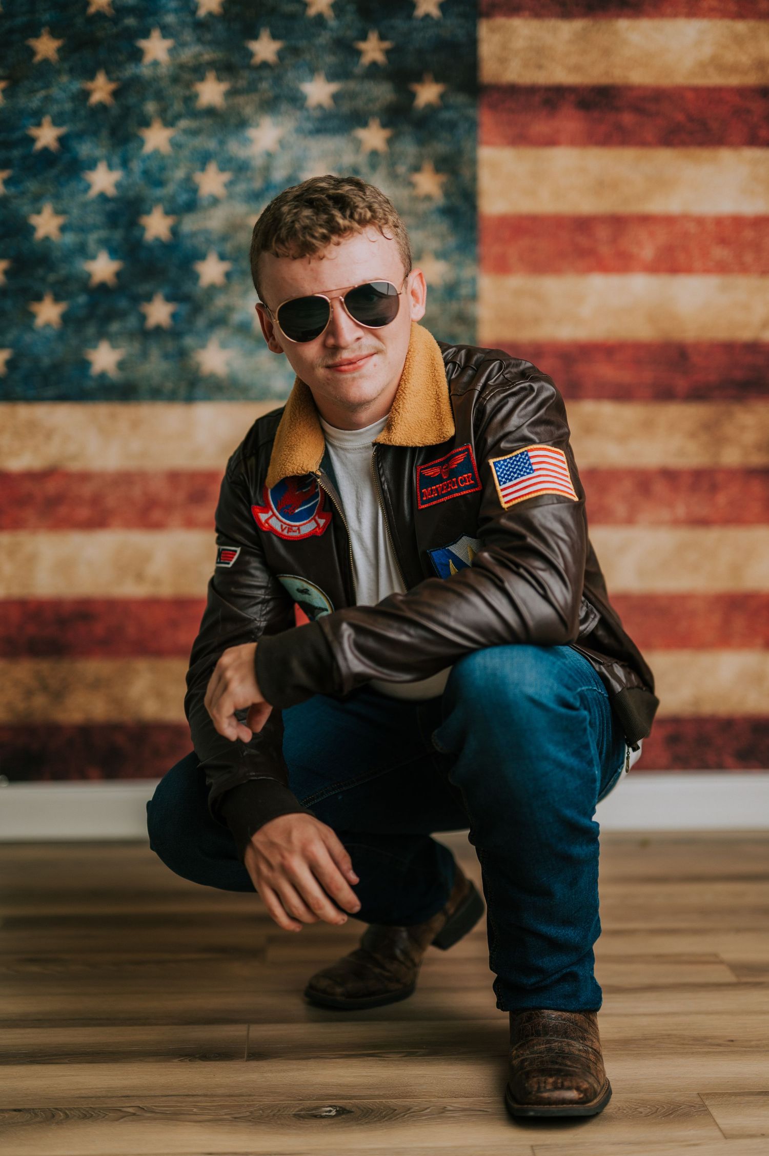 Stylish portraits against an American flag backdrop featuring leather jacket and sunglasses.