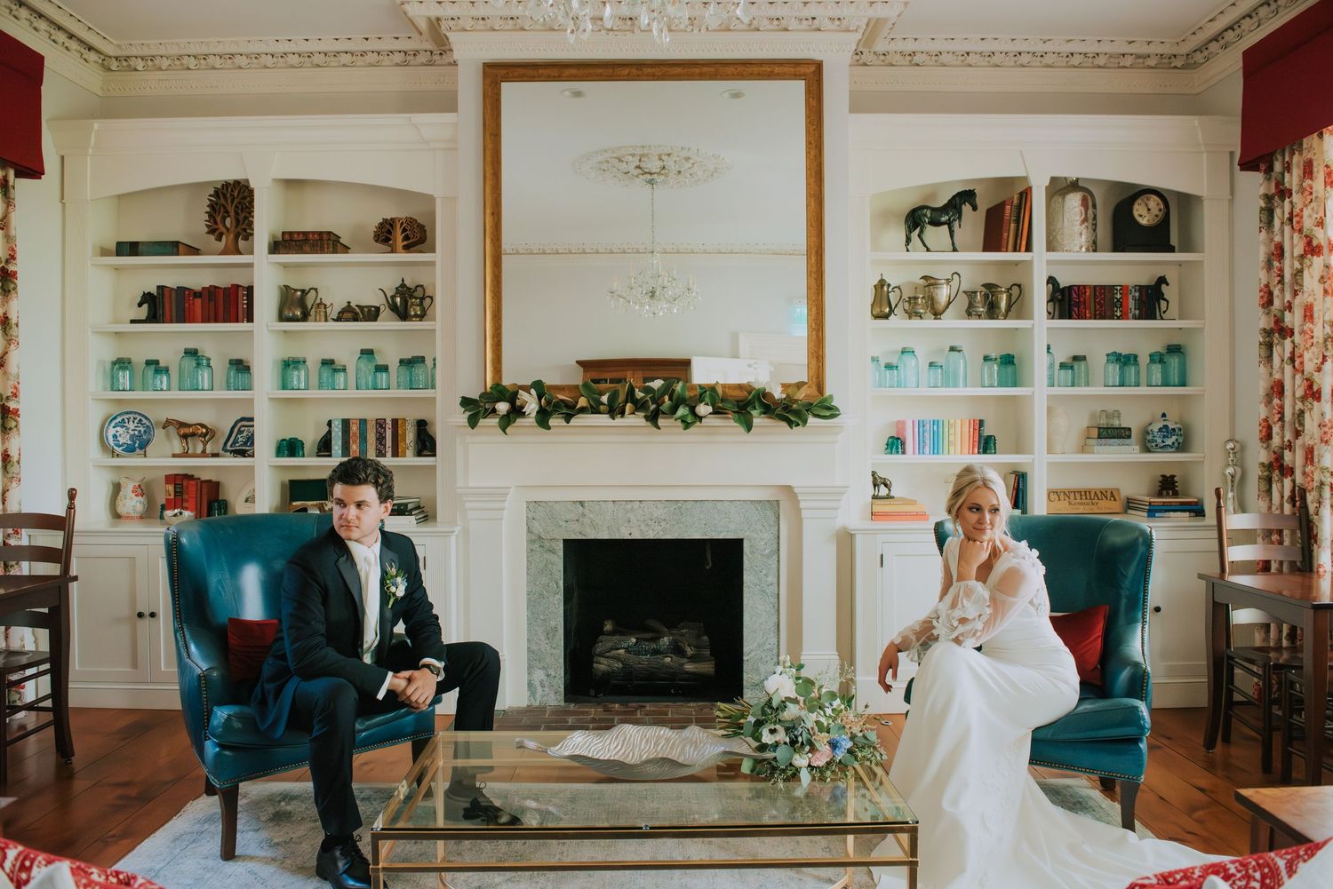 Elegant library room with ornate molding and built-in bookshelves decorated for wedding.