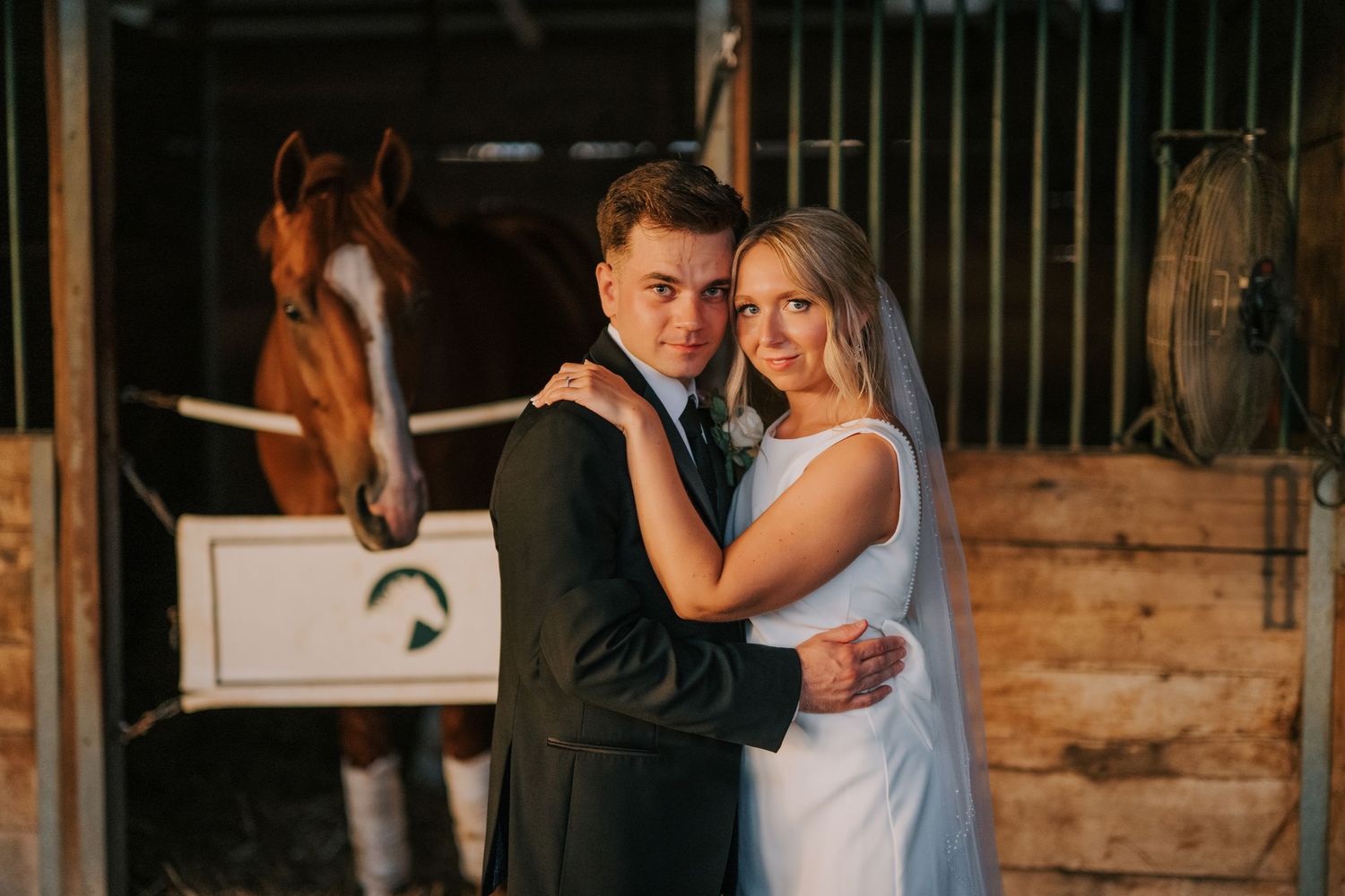 A rustic barn wedding venue decorated with elegant lighting and wooden details.