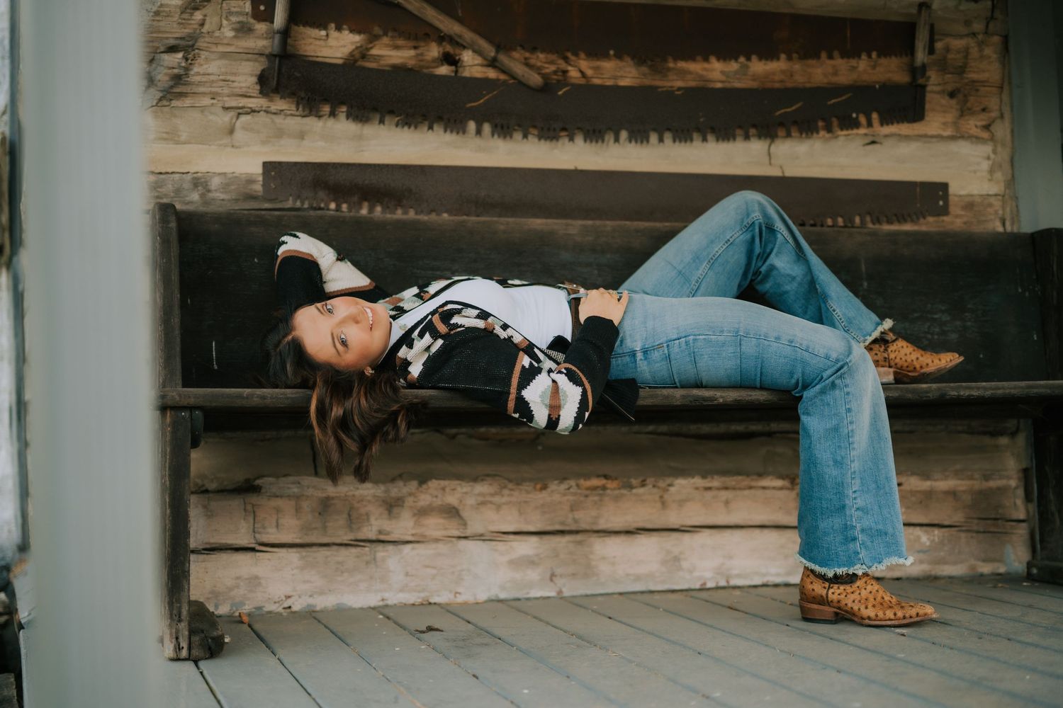 Artistic low-angle shot of person reclining on wooden deck.