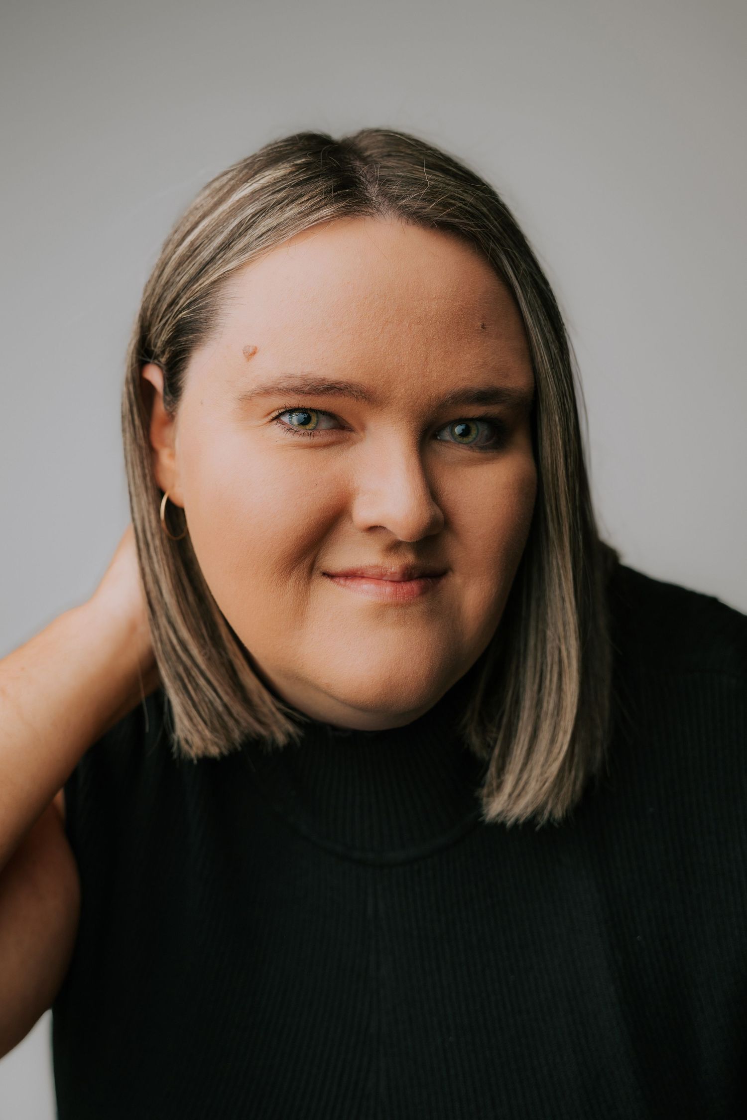 Studio portraits showing expressive poses against neutral background.