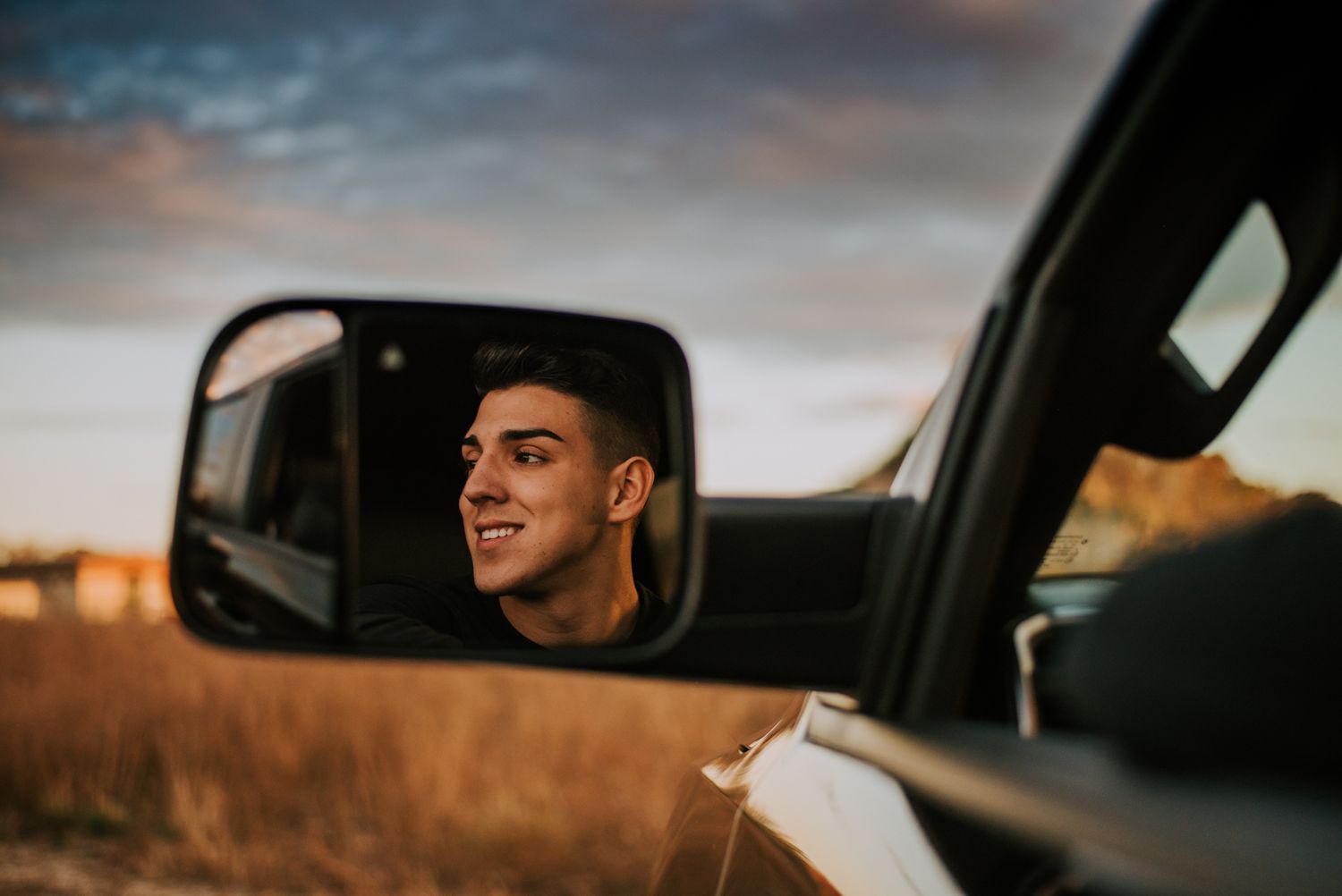 A dramatic sunset photoshoot featuring a black truck silhouette.