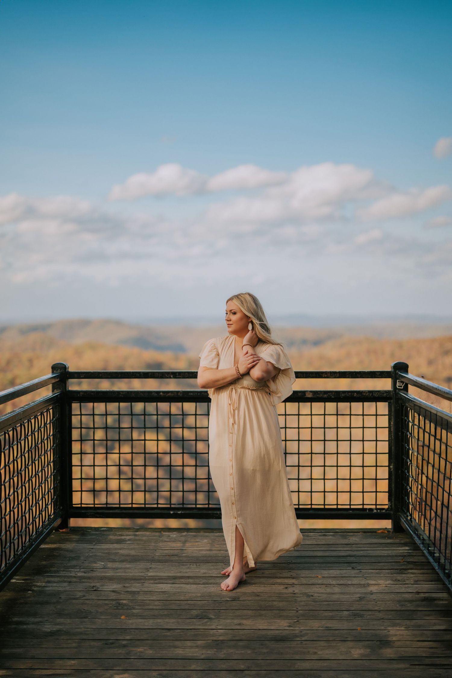 Wooden observation deck overlooking mountain views on a clear autumn day.