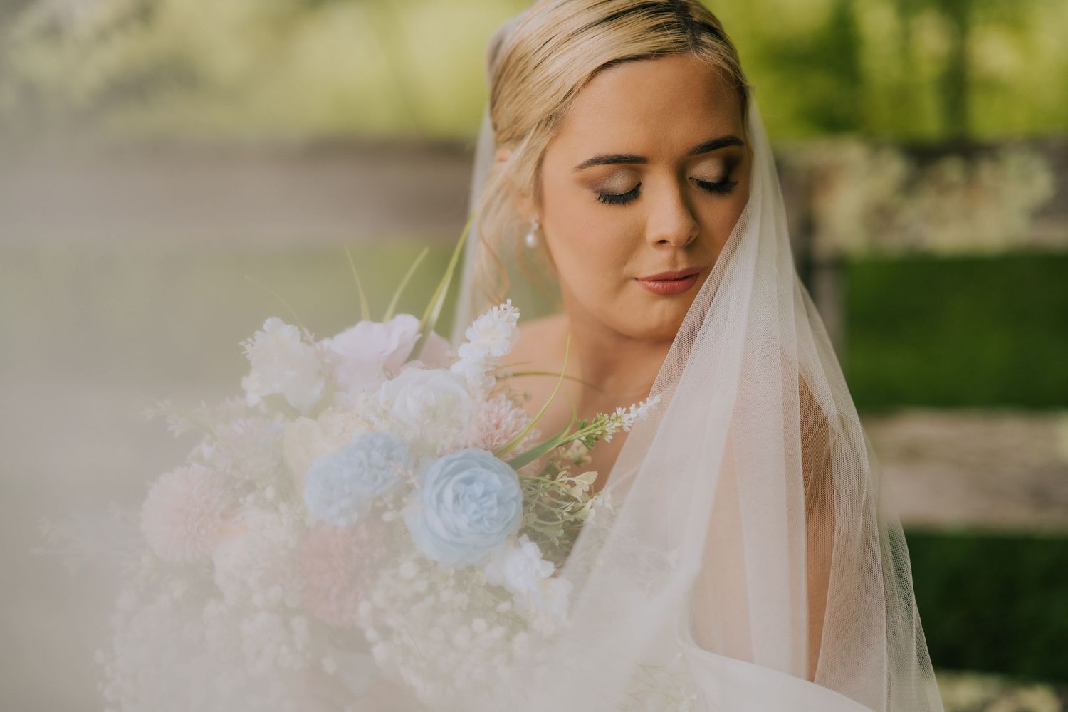 Close-up details of a bridal look featuring soft lighting and delicate flowers.
