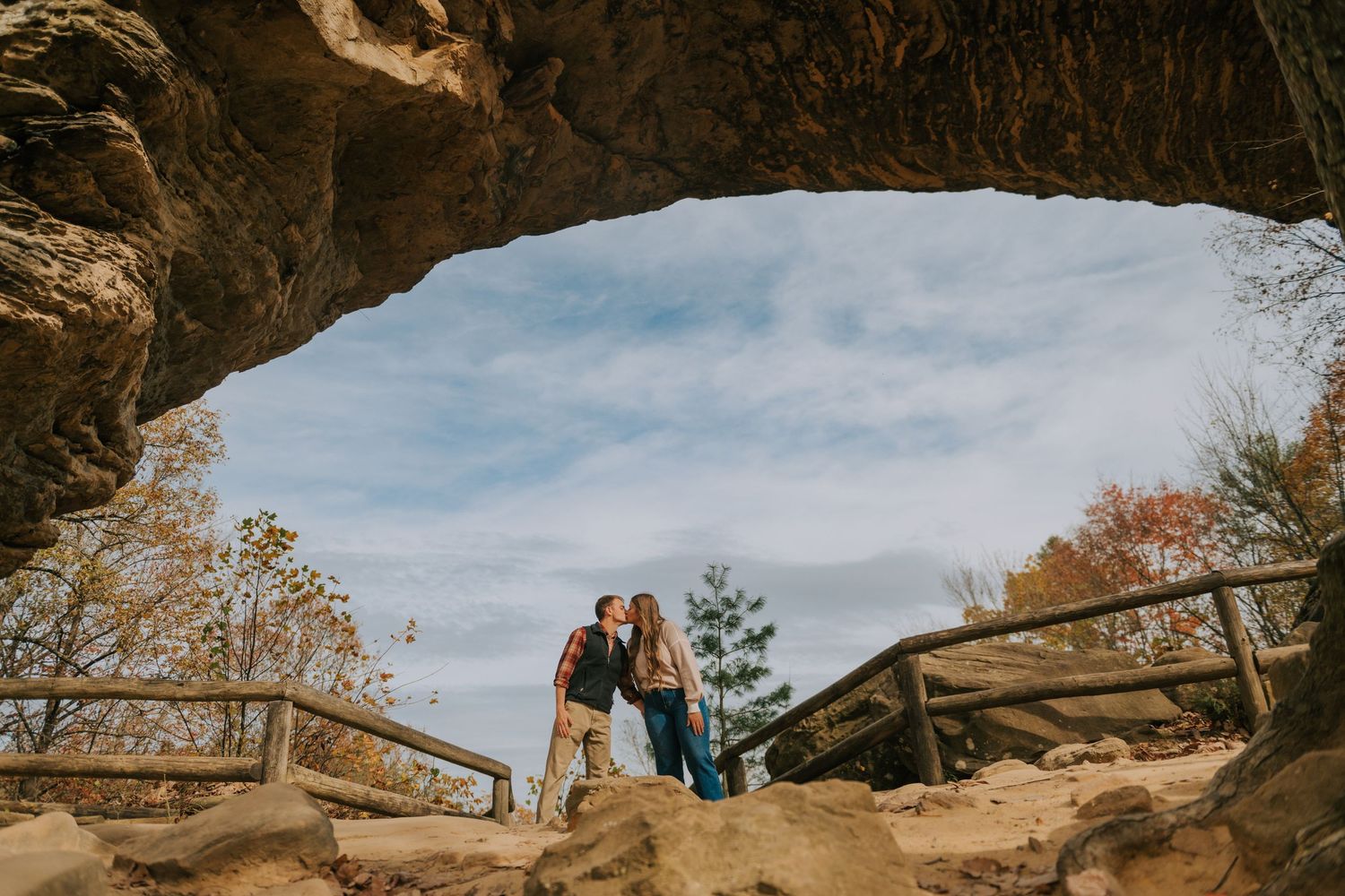 Natural rock formations and caves with blue sky visible through the openings.