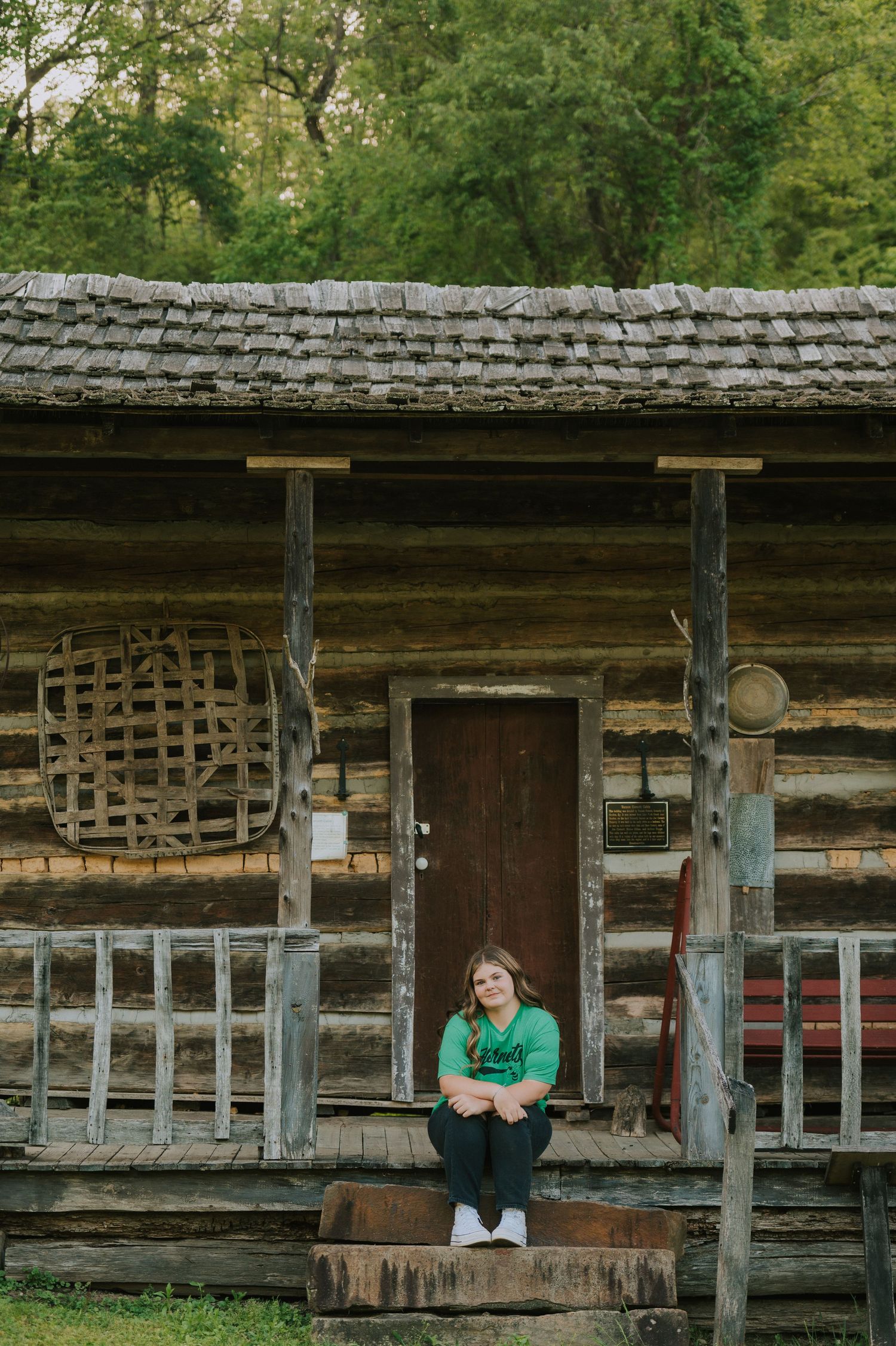 A rustic log cabin with wooden beams and vintage architectural details in a woodland setting.